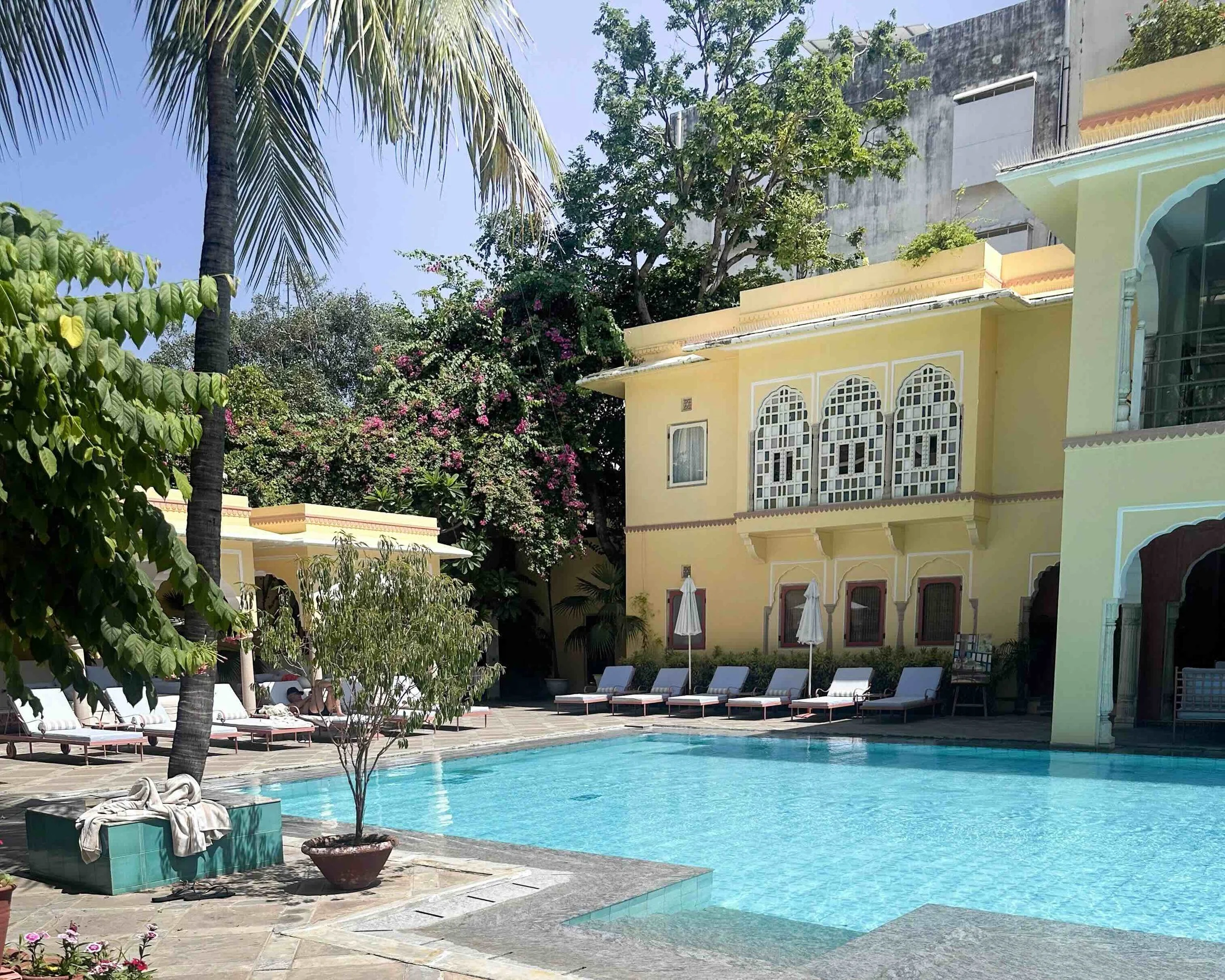 Pool and ornate yellow building at Samode Haveli heritage hotel, Jaipur, Rajasthan-India with Bernadette
