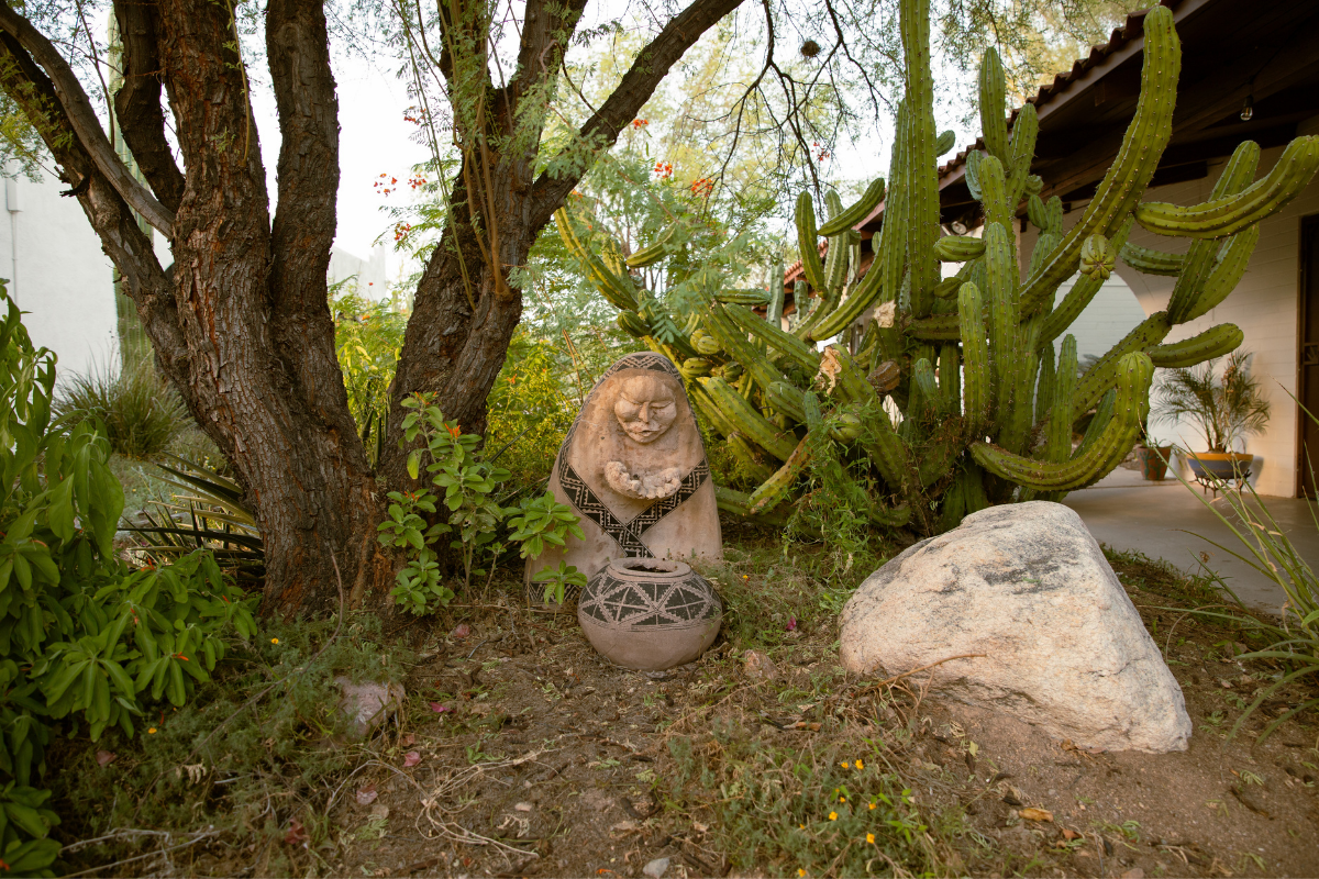A statue nestled beneath the Mesquite trees outside The Casitas