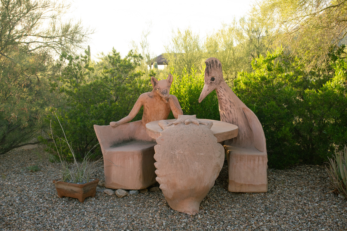 Sculptures by Kit Schweitzer of desert animals gathered in front of Cat Mountain, waiting for you to join them