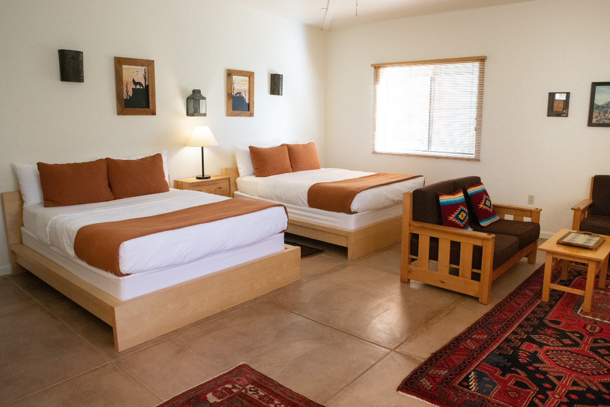 The bedroom in Kerstin's Suite, featuring two Queen beds and generous natural lighting