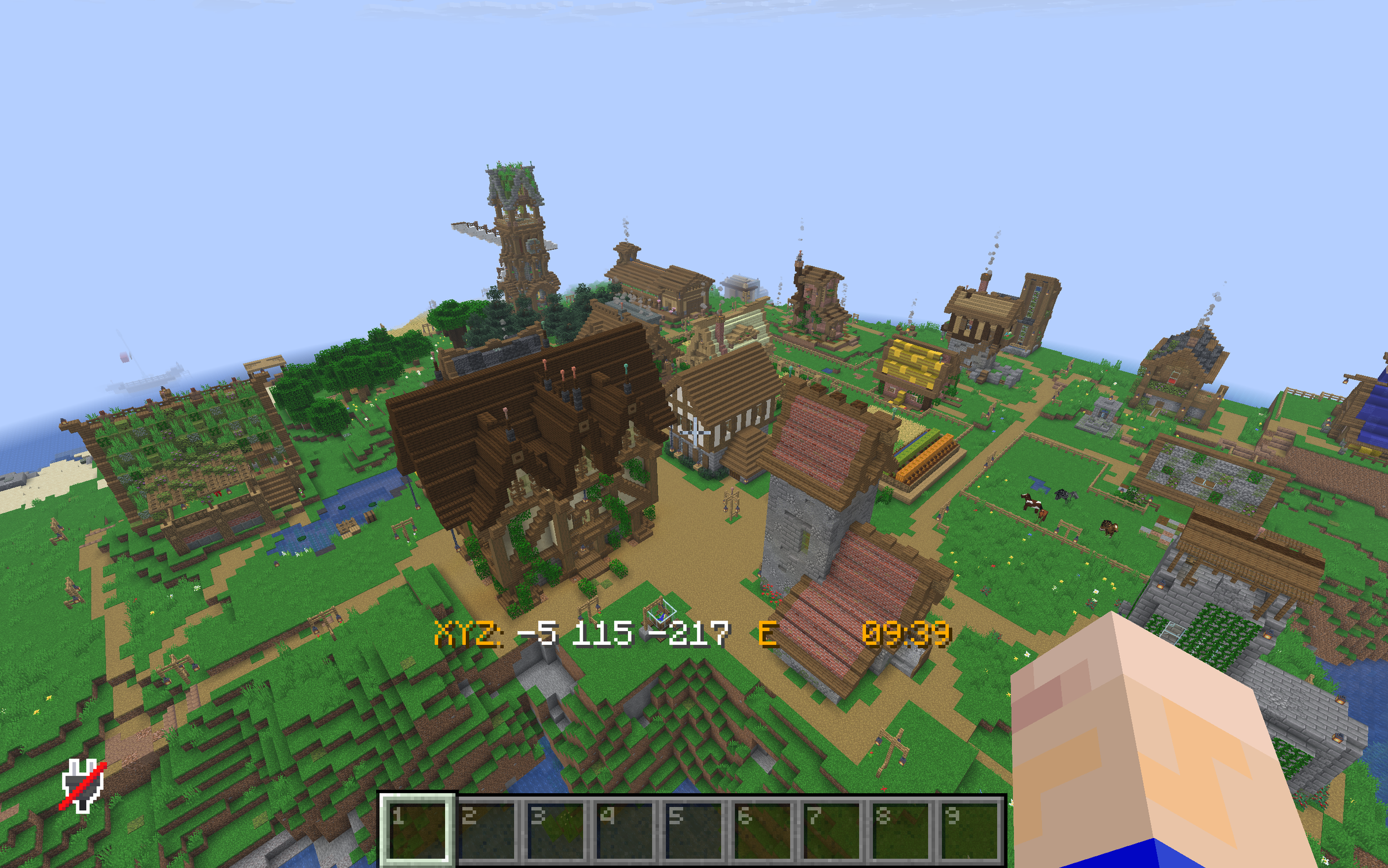 Ein Blick auf eine in Minecraft gebaute mittelalterliche Stadt mit verschiedenen Gebäuden, Türmen und Straßen, direkt aus der Vogelperspektive aufgenommen.