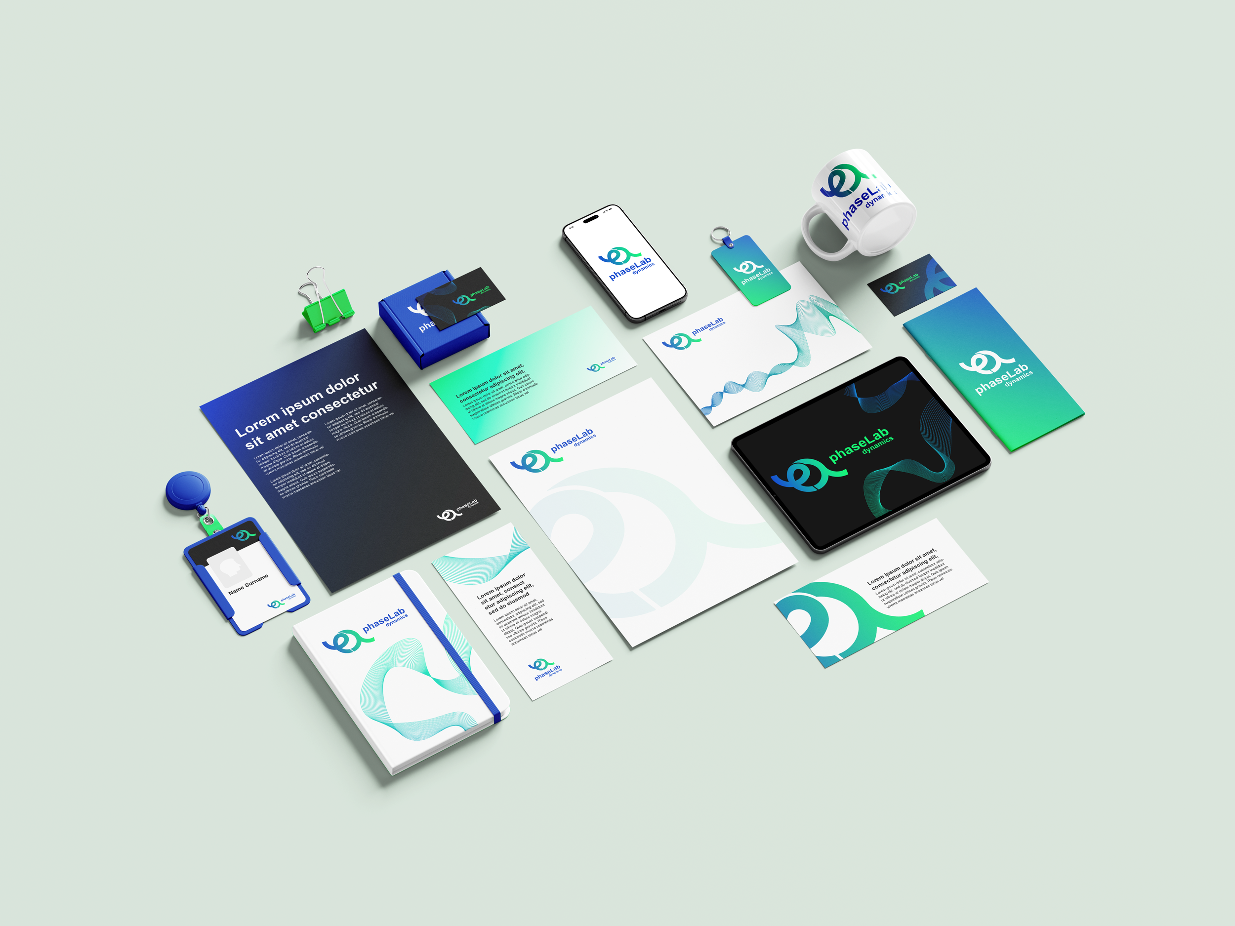 Collection of stationery and branded items for a company named PhaseLab, including business cards, brochures, notebooks, a tablet, a smartphone, a coffee mug, a badge, and paper with the company's logo and branding.