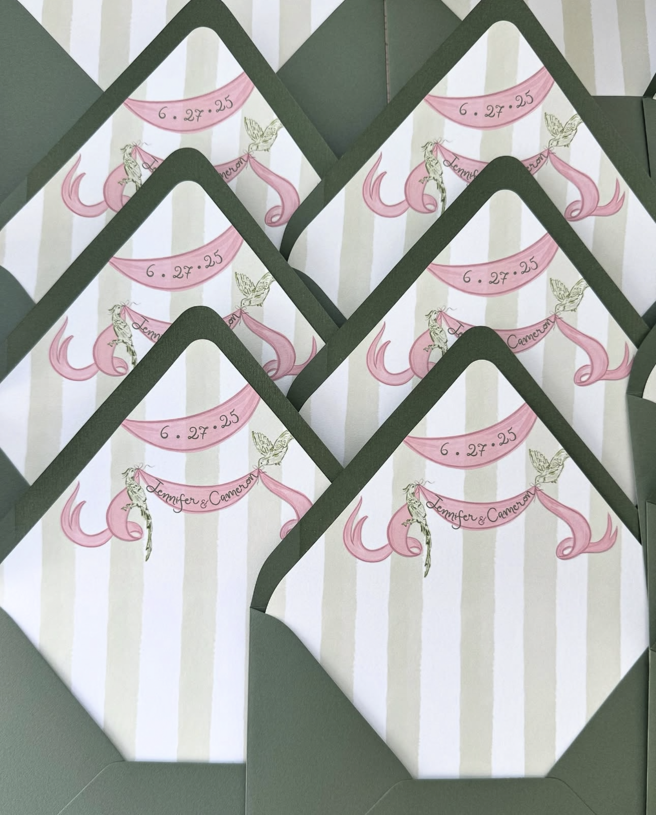 Wedding invitation cards with pink mermaid illustration, striped background, and green border, featuring the date '6.27.25' and the names Jennifer & Cameron.