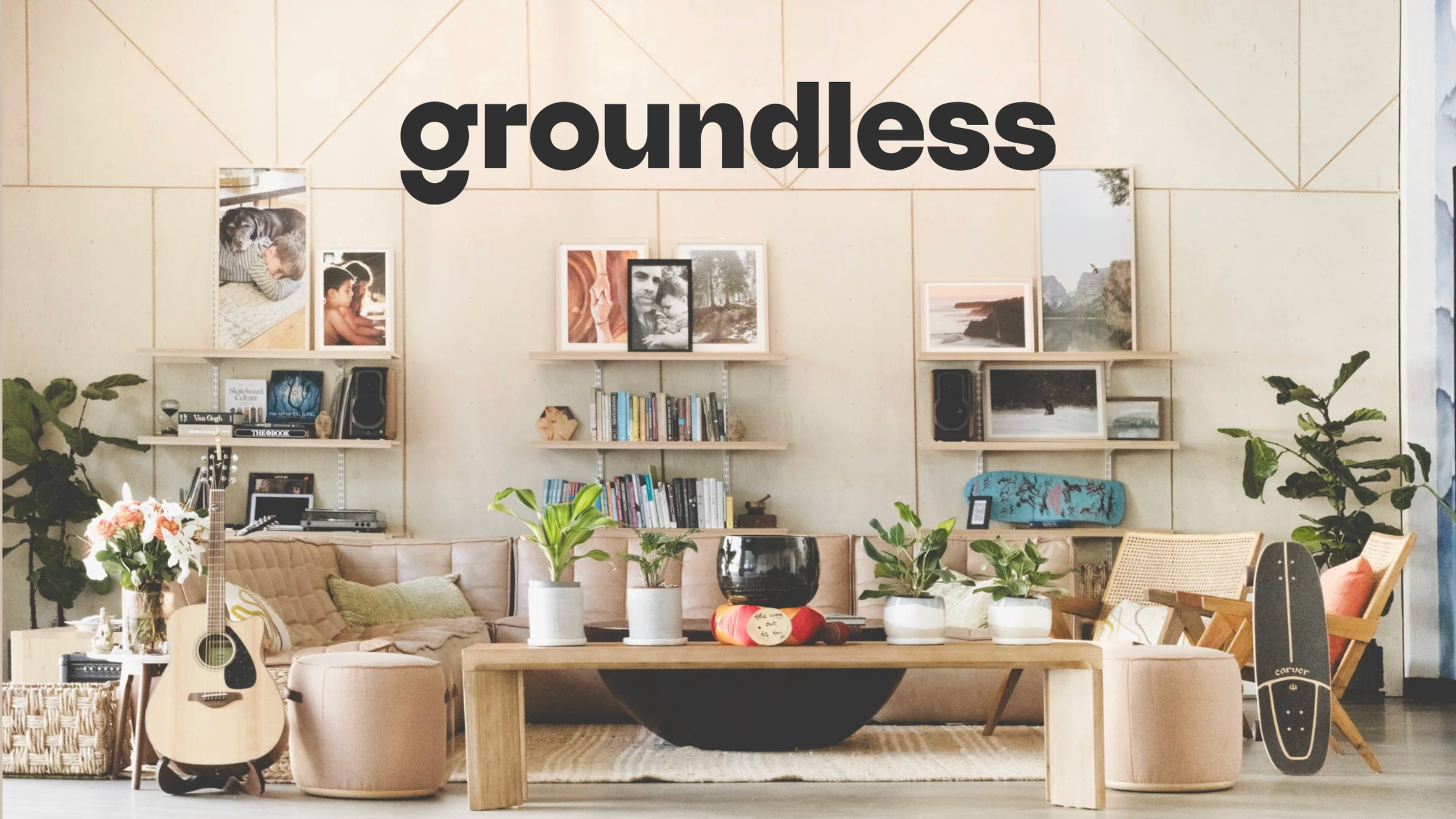 Living room with beige sofa, plants, guitar, bookshelf, wall art, skateboard, and a cozy, modern decor.