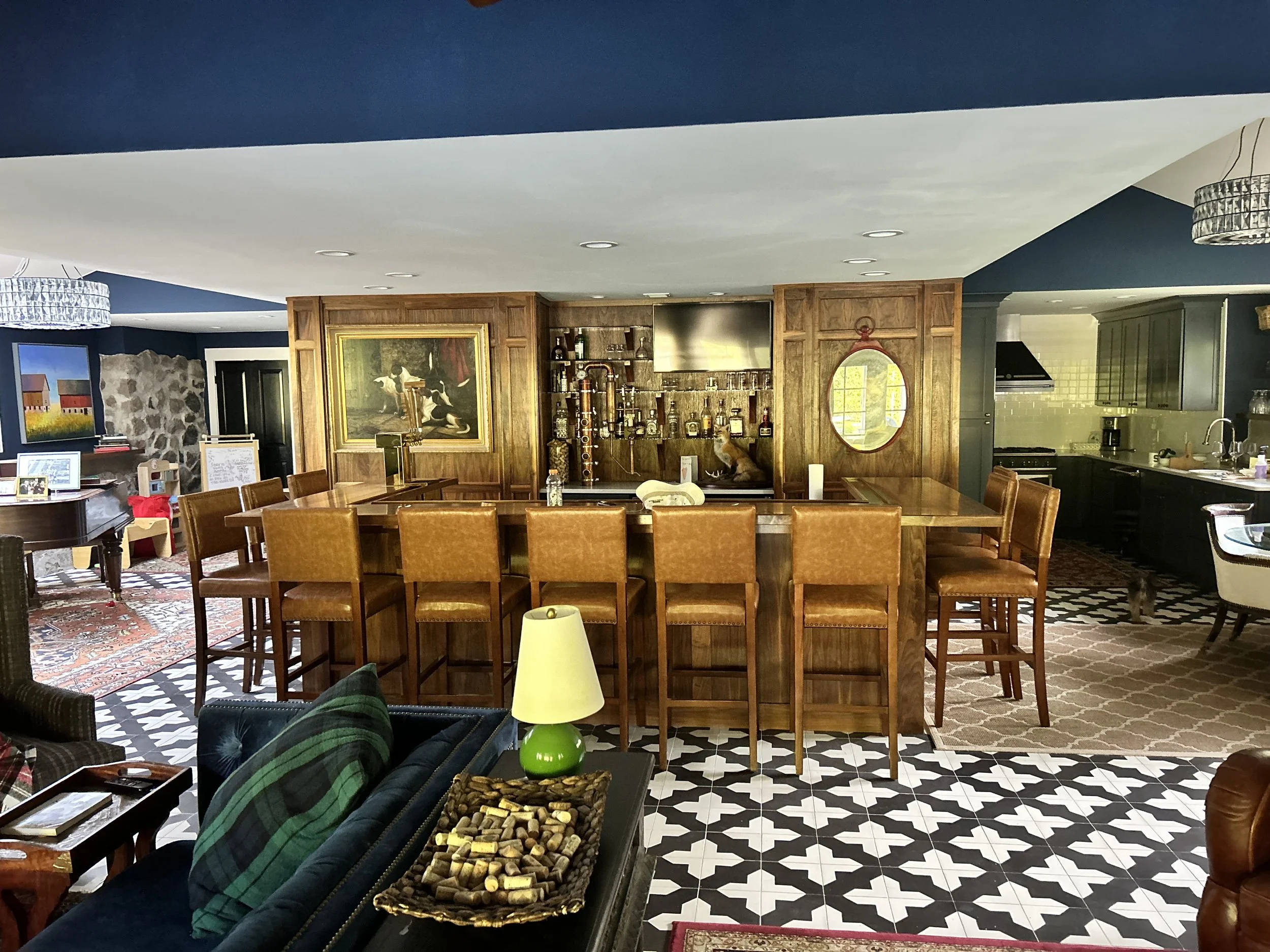 After: A stunning bar area by MichaelAngela Properties, featuring Nicaraguan Cement tiles, a full kitchen with high end appliances, elegant decor, transforming the space into a luxurious, functional area. 