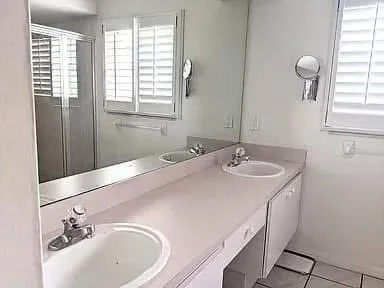 Before - nineteen nineties bath with dated pinks, tired tile, begging for change. 