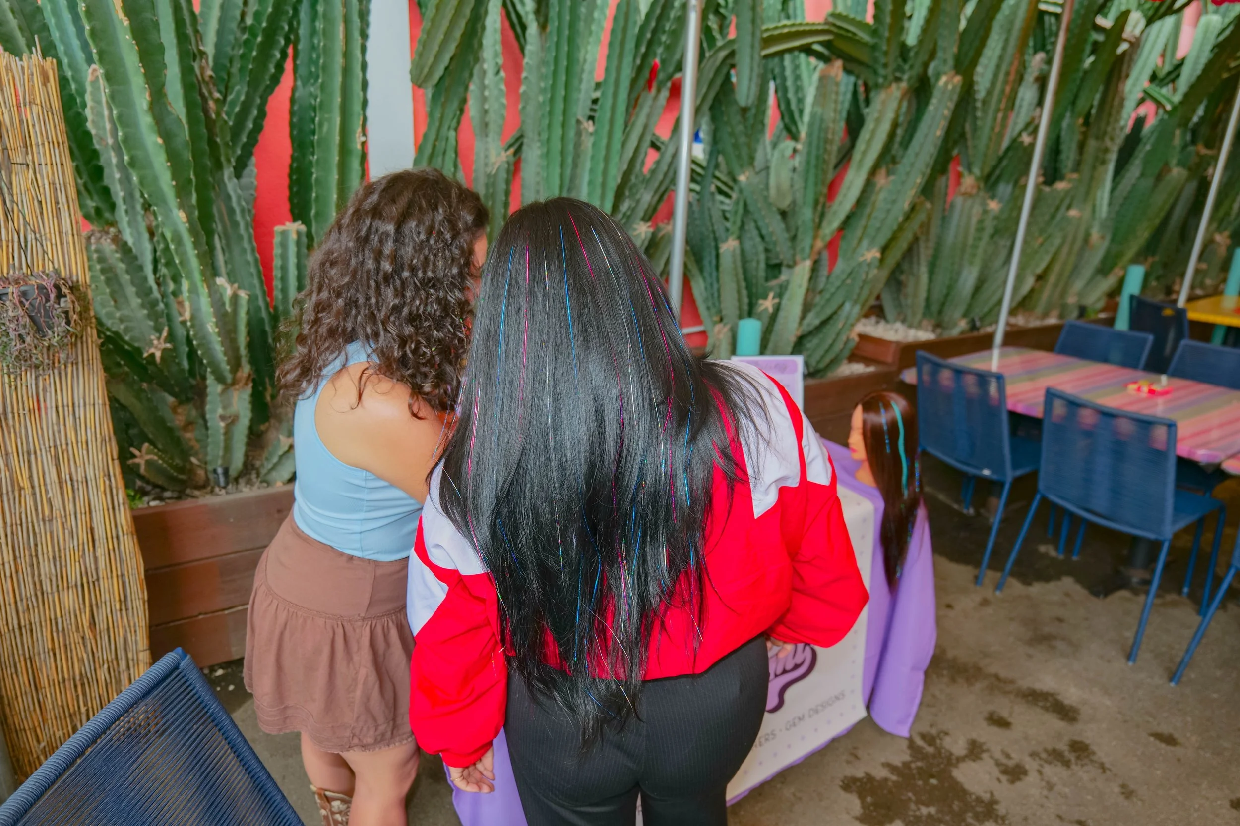 helping client choose tinsel colors for long black hair