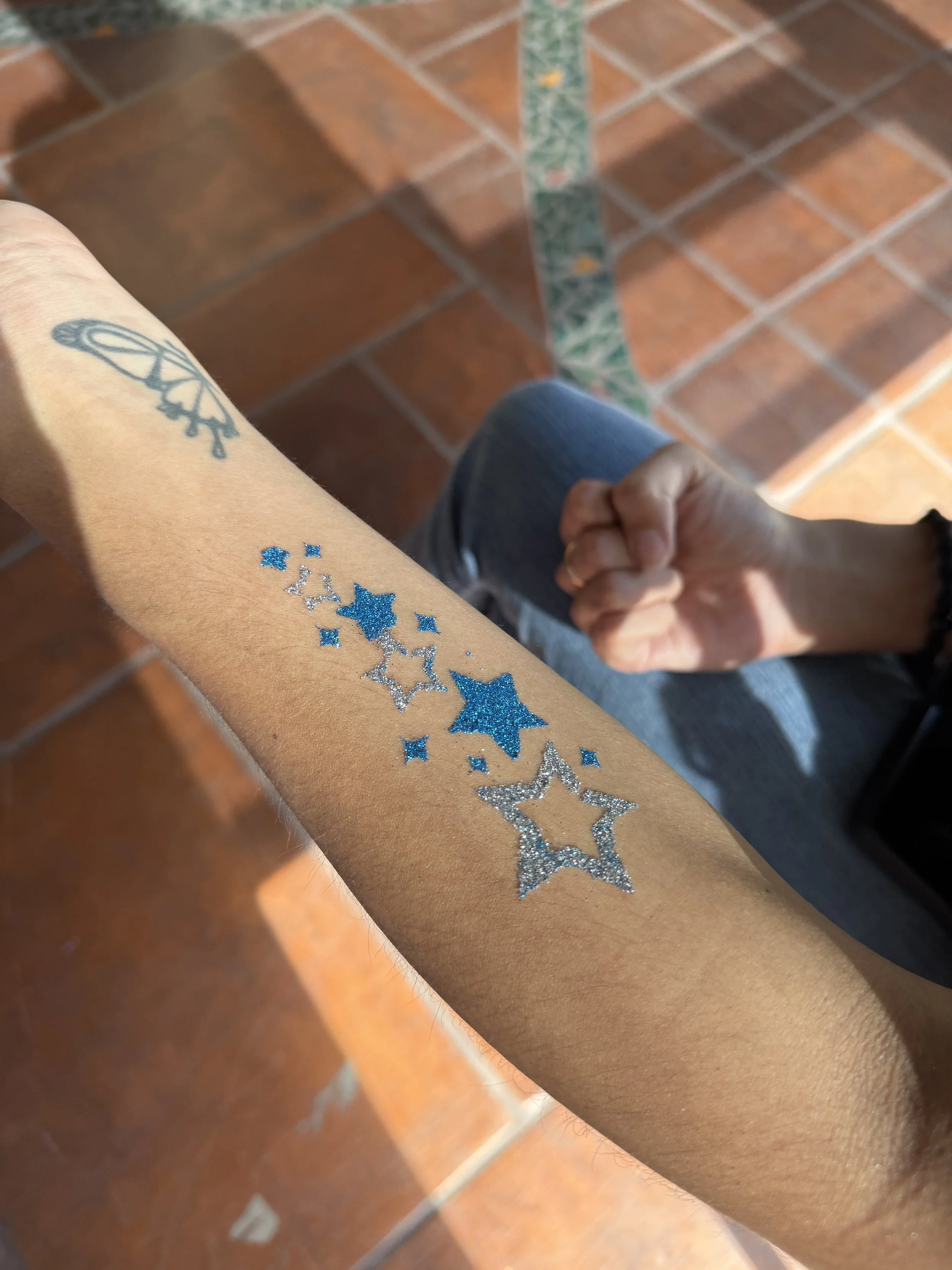 stars glitter tattoo on arm blue and silver