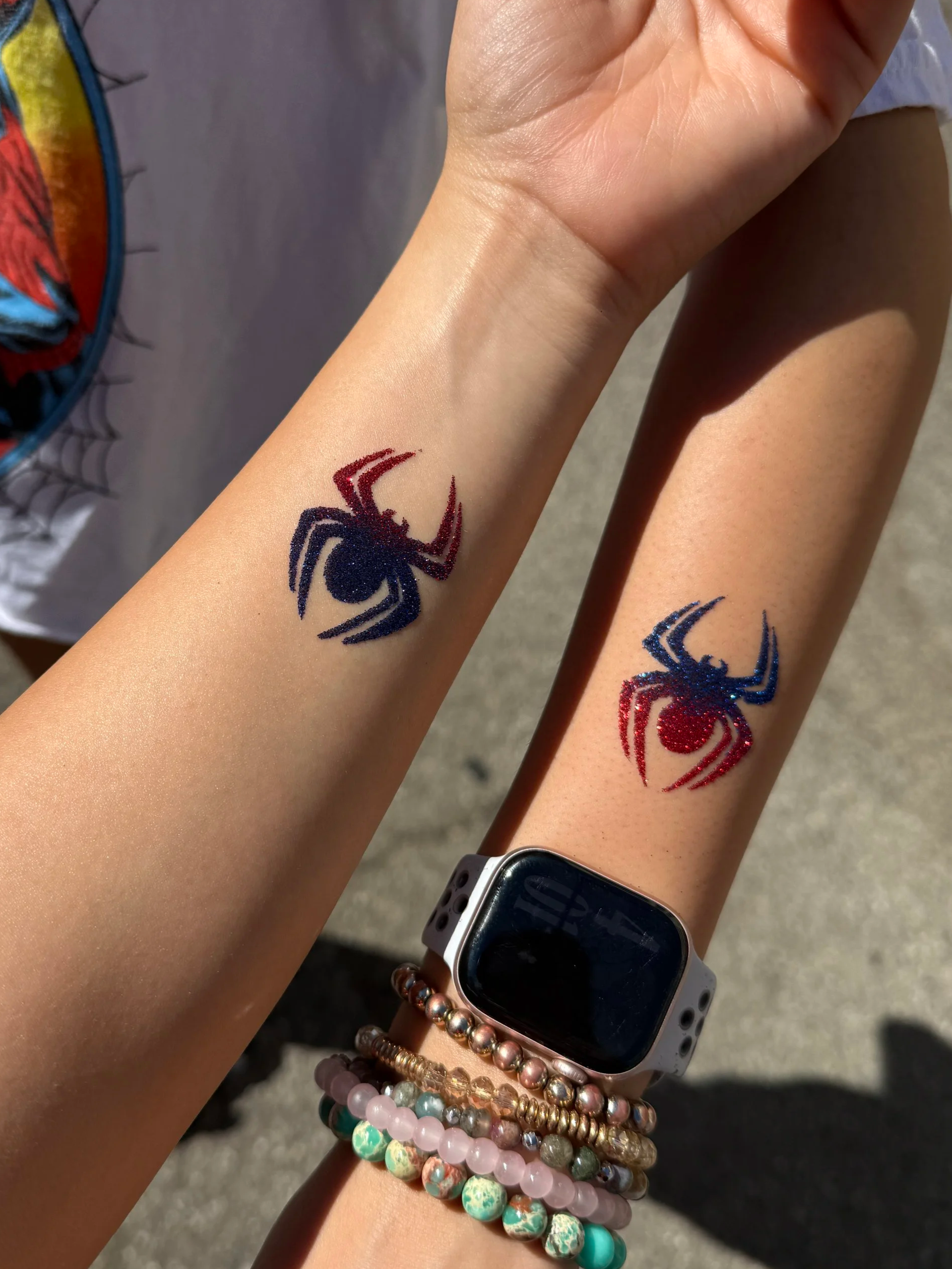 Spider glitter tattoo design on arm