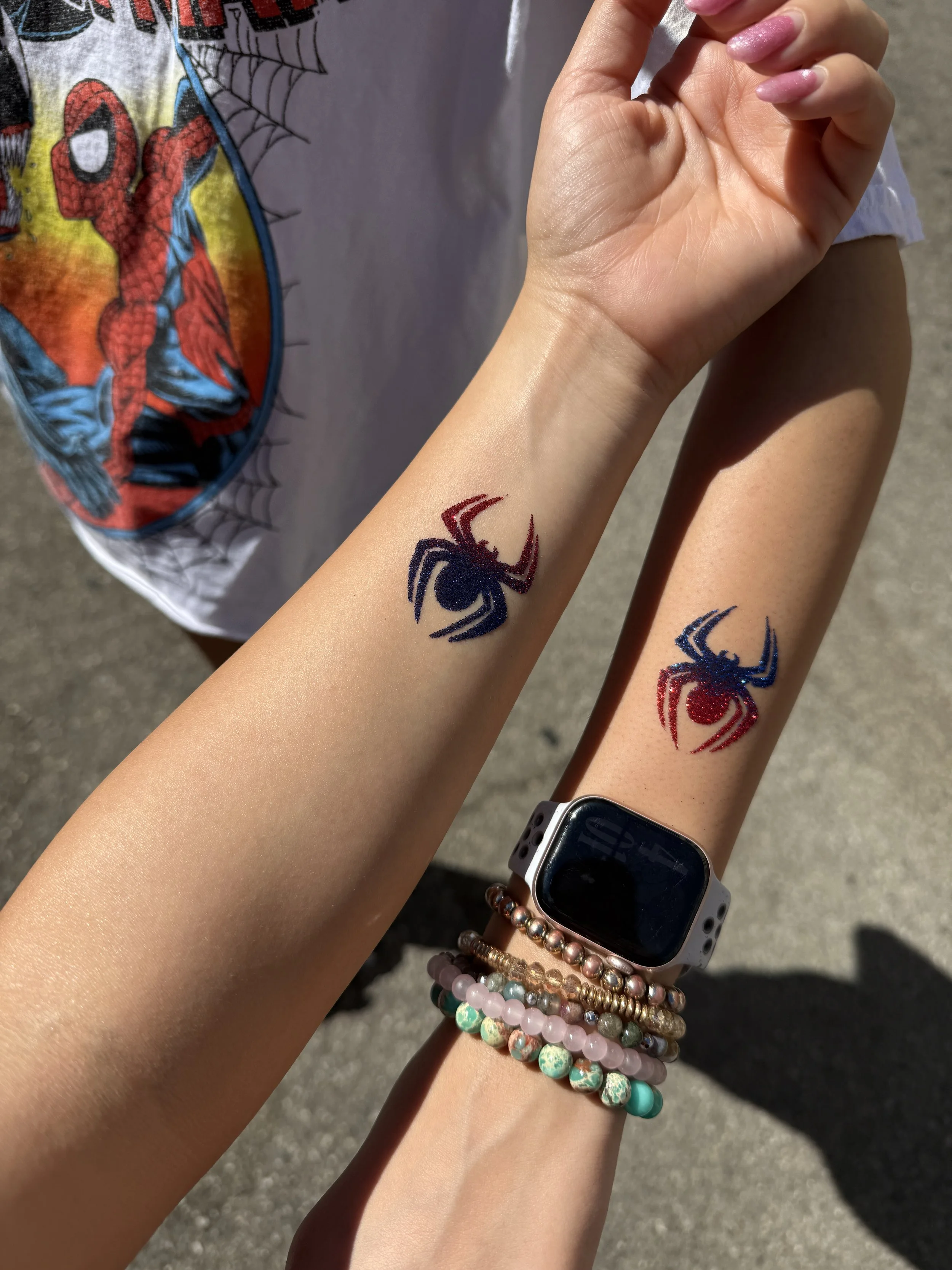 matching sister glitter tattoos on arm spiderman