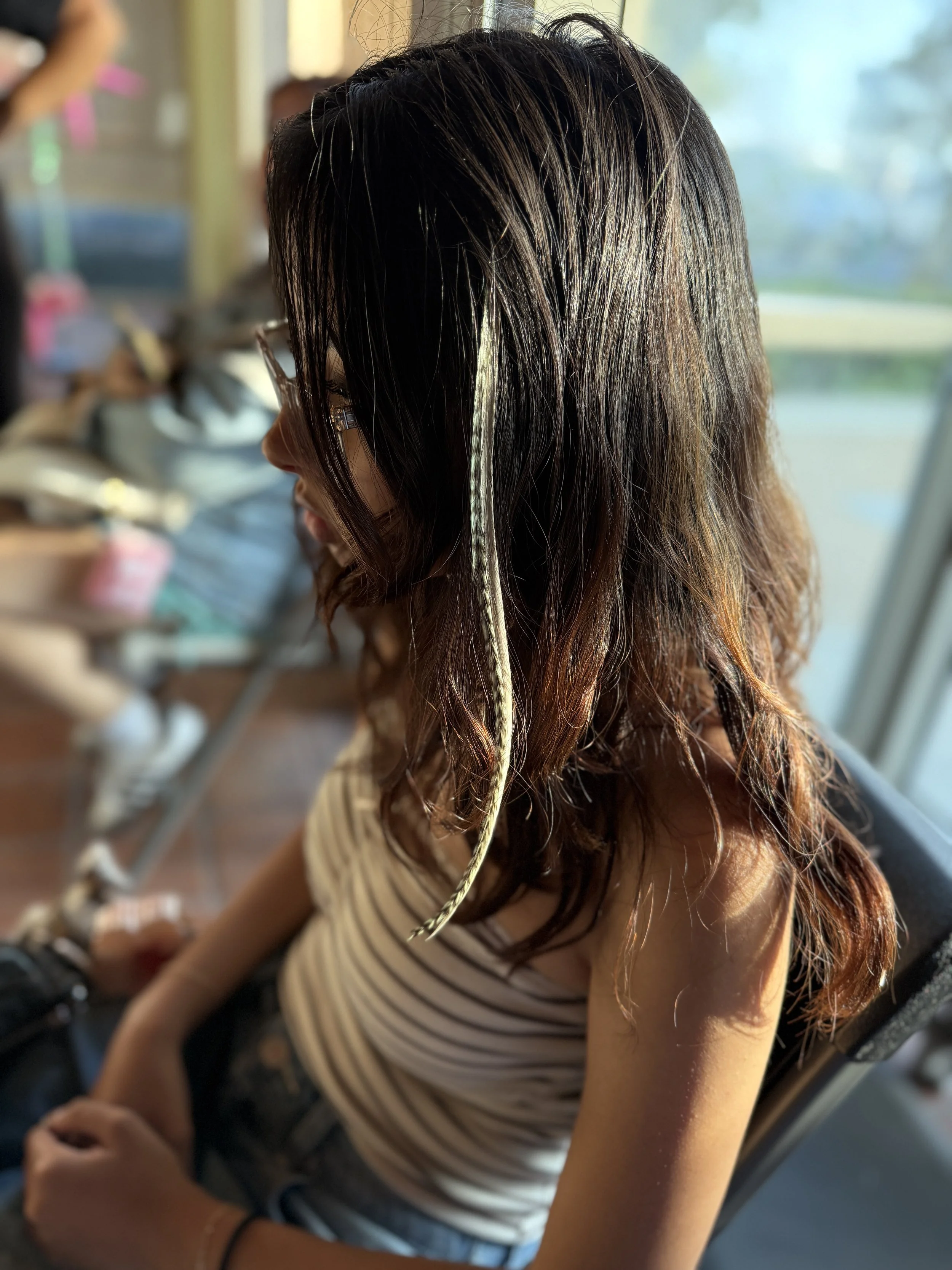 natural colored feather hair extensions in dark hair
