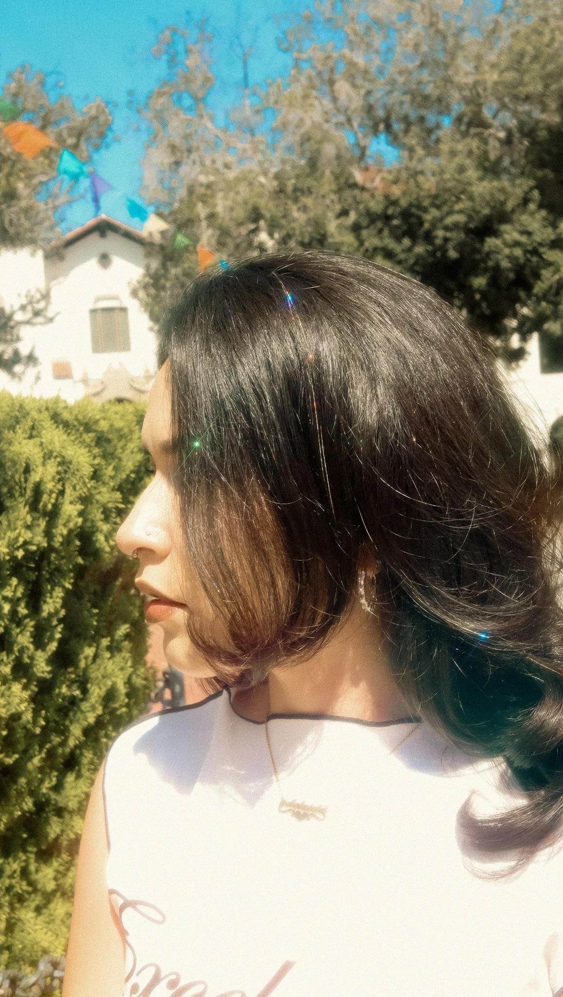 Hair tinsel in dark hair, outdoor photo