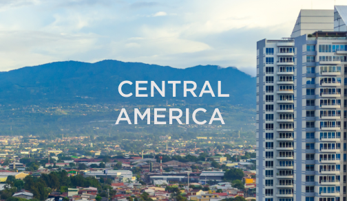 Cityscape with a modern high-rise building and mountains in the background with “Central America” overlay, representing hospitality markets served by DC Global Talent recruitment specialists.