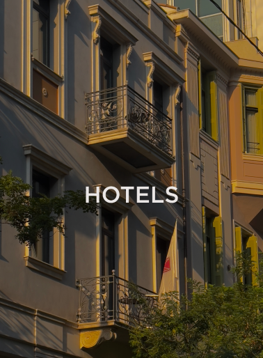 Facade of a multi-story hotel building with balconies and windows and “Hotels” text overlay, representing hospitality properties served by DC Global Talent recruitment specialists.