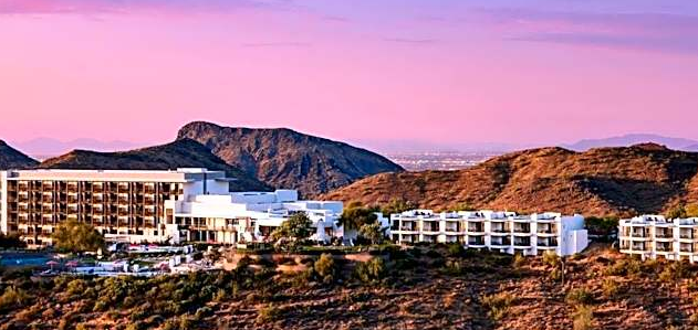 Adero Resort in Scottsdale, Arizona with luxury resort buildings nestled in a hilly desert landscape at sunset, representing hospitality destinations served by DC Global Talent recruitment specialists.