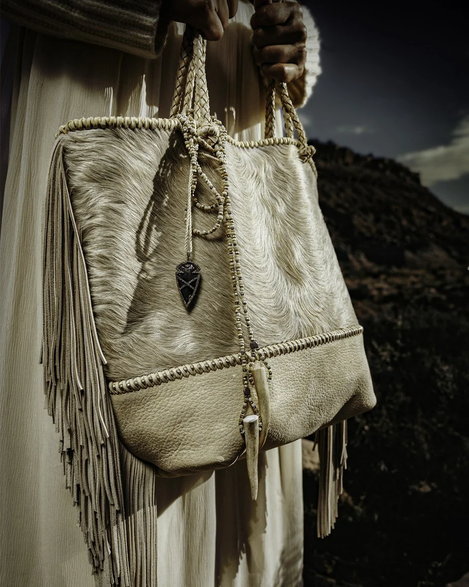 Skadi tote : a labor lovve. Showcasing hair on hide, African beading, hand-cut fringe and handles, and our beautiful "Luxana" arrowhead pendant charm.