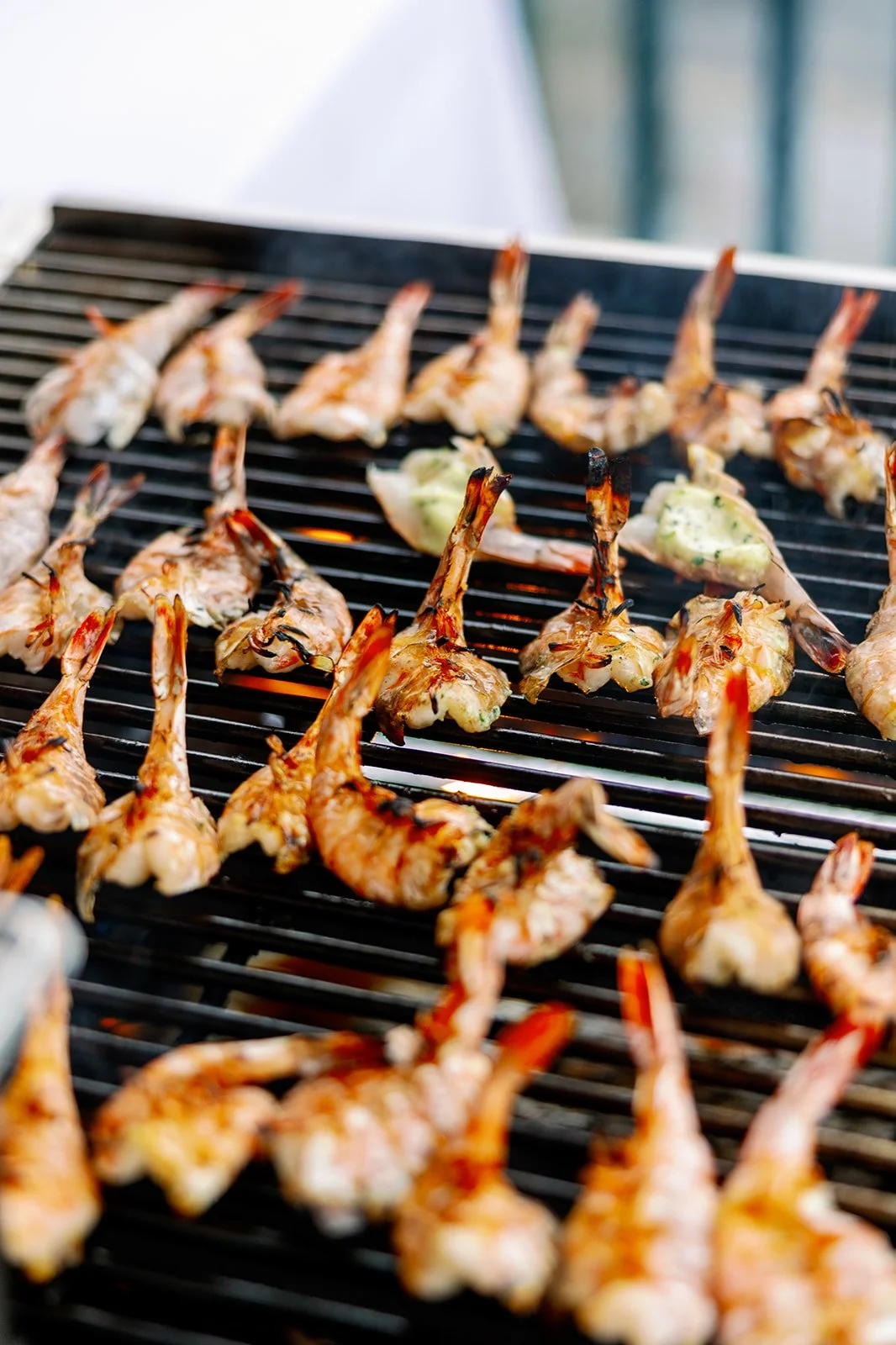 Shrimp skewers cooking on a barbecue grill.