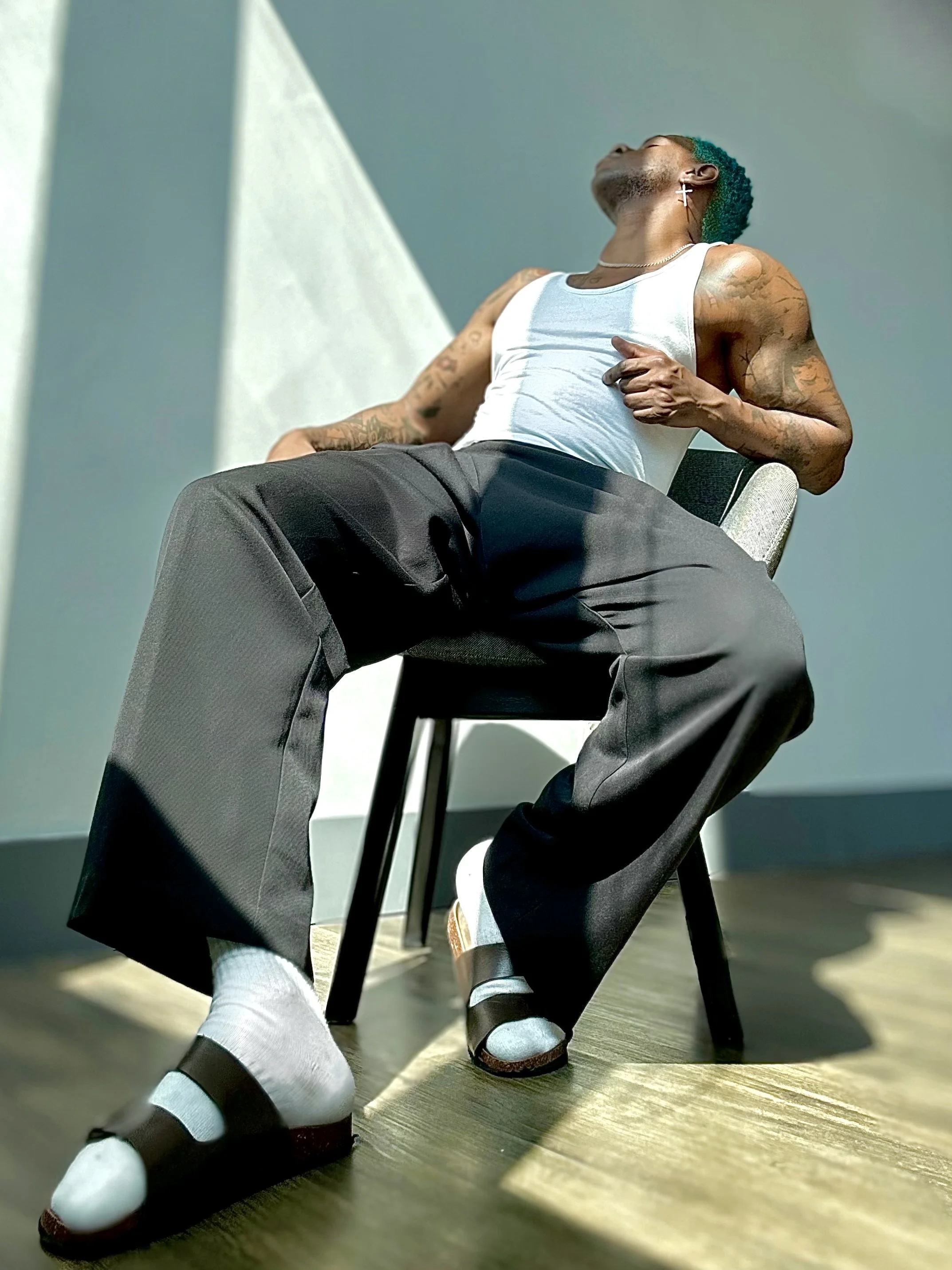 Sitting on a chair in brazil wearing a tank top and sandals