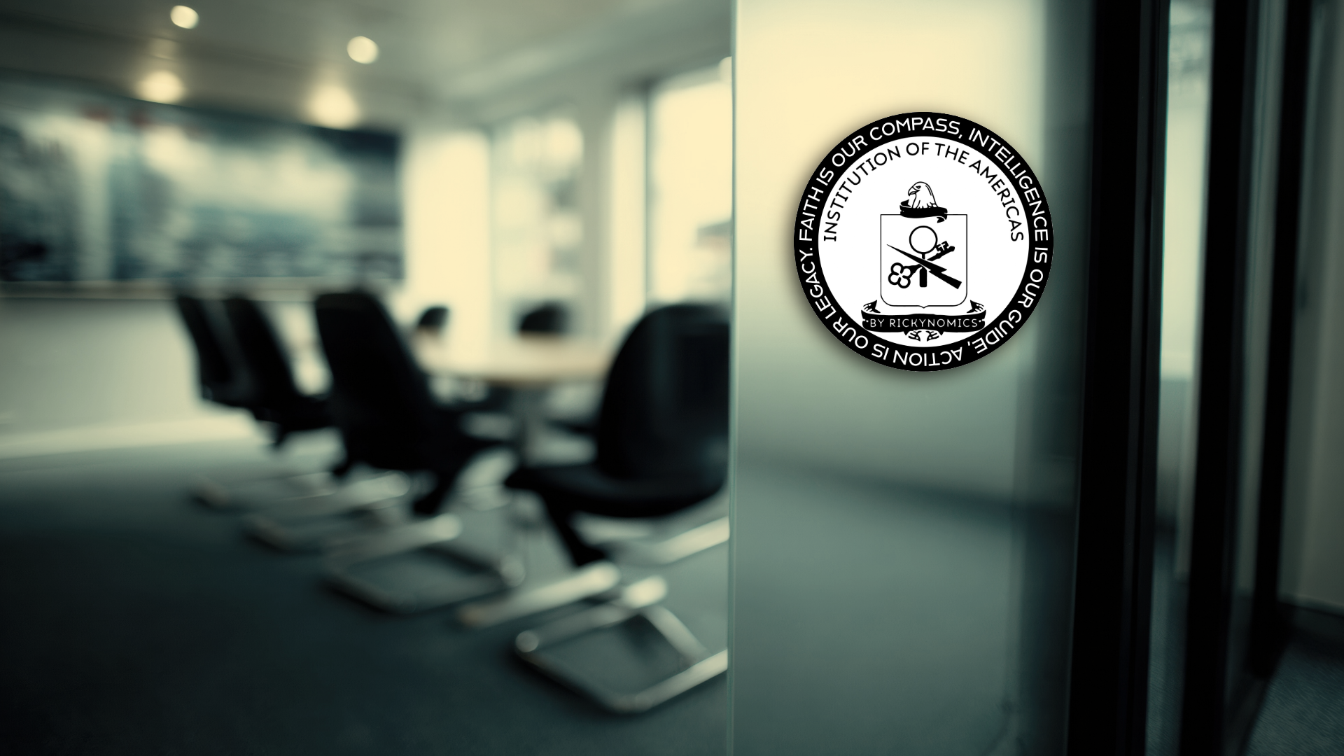 A conference room with a white round table and black chairs, with a wall-mounted screen at the front. A circular sticker with the American eagle emblem and quote about American exceptionalism is on a glass partition.