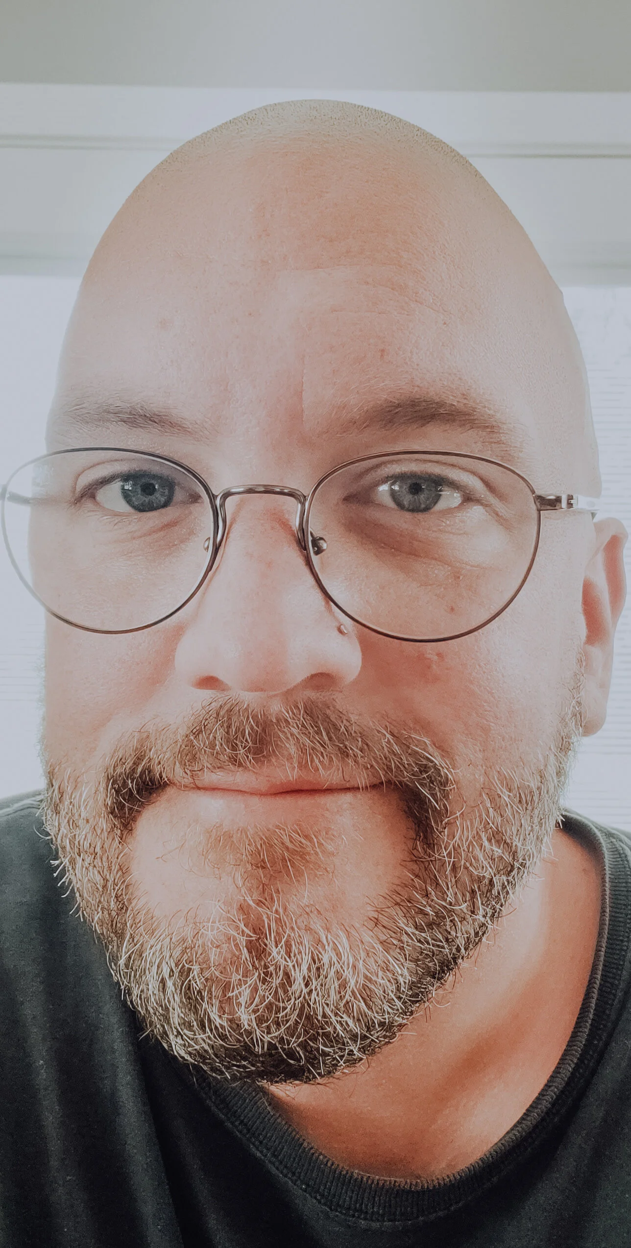 A photo of Adam smiling into the camera.