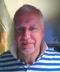 A selfie from Graham wearing a blue and white-striped shirt.