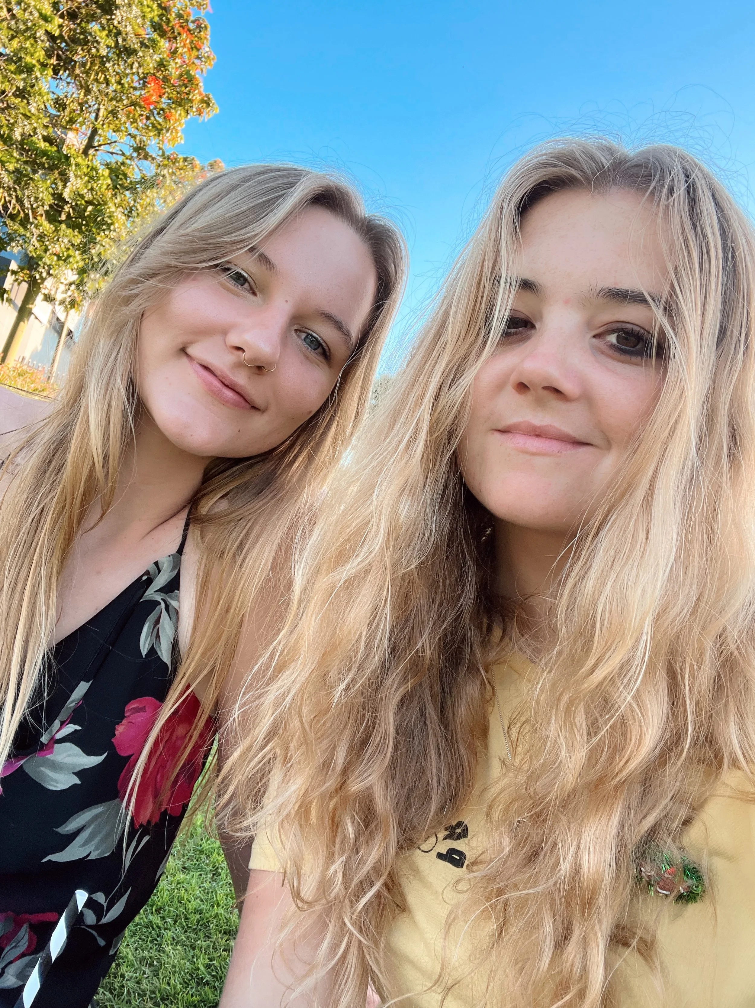 A photo of Keziah and her partner taking a selfie in a park.