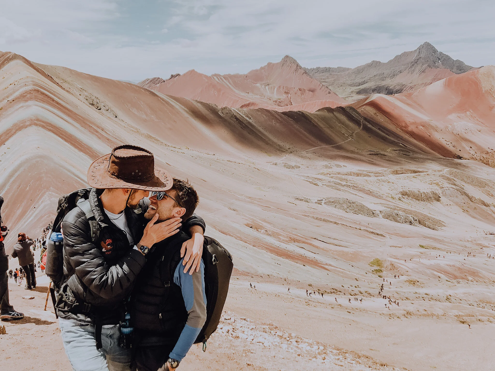 A photo of Kirk and his partner appearing about to kiss as they hike in Peru.