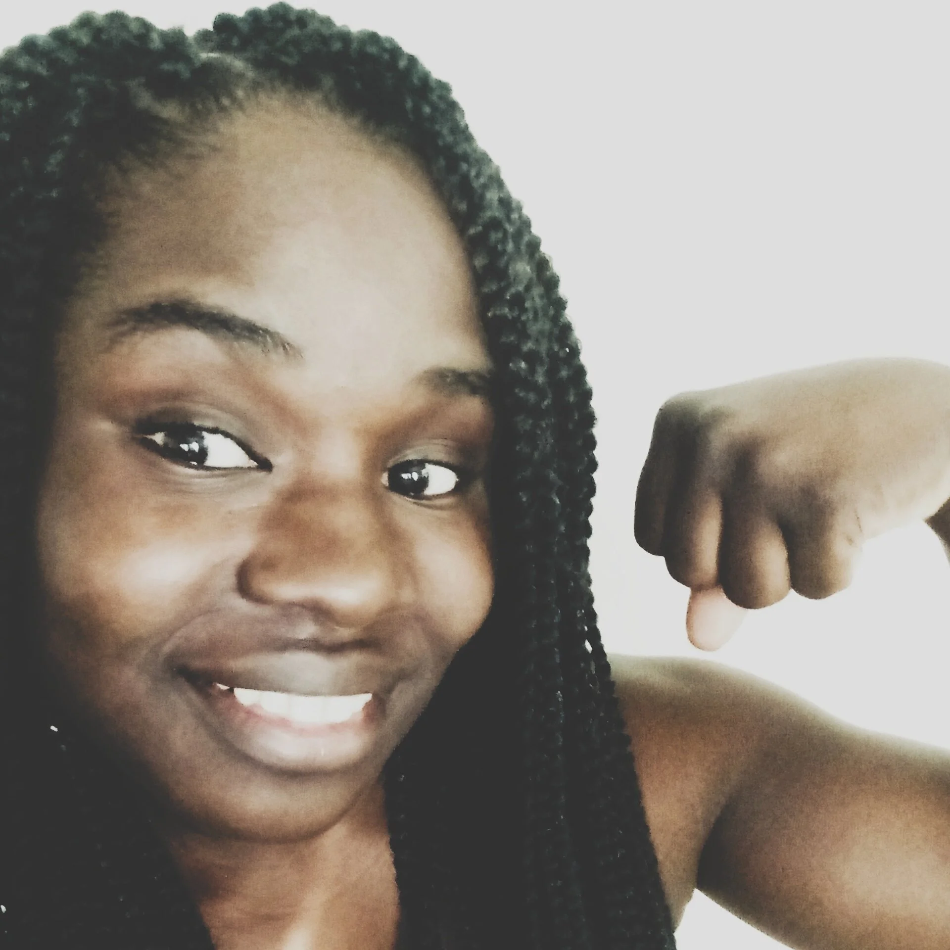 A photo of Sequana taking a selfie while flexing her left arm.