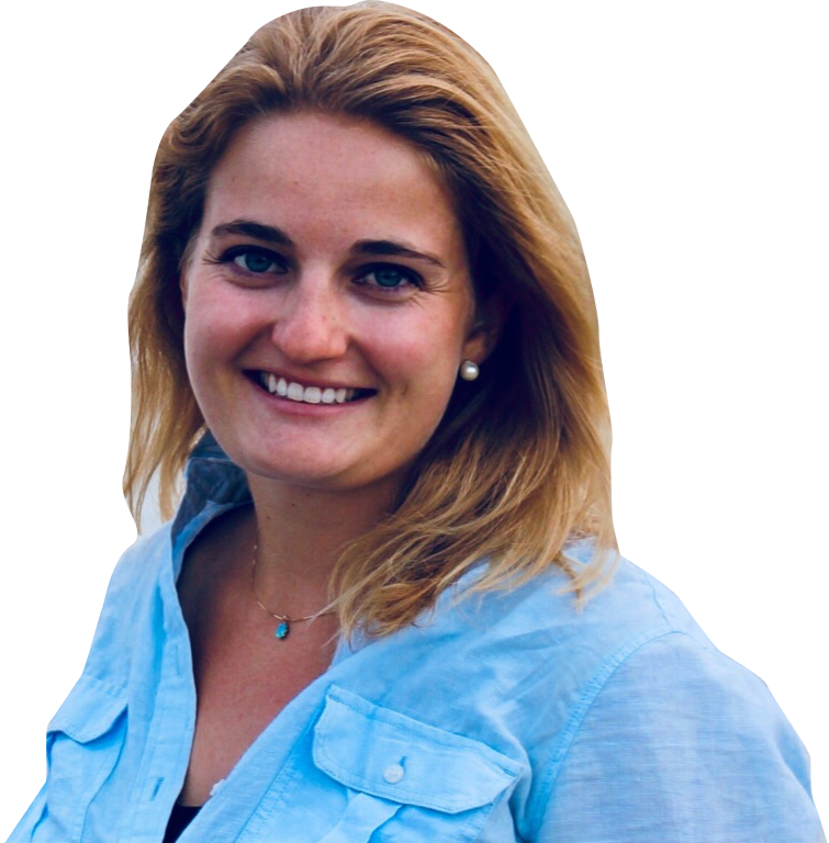 Smiling woman with blonde hair wearing a light blue shirt and pearl earrings.