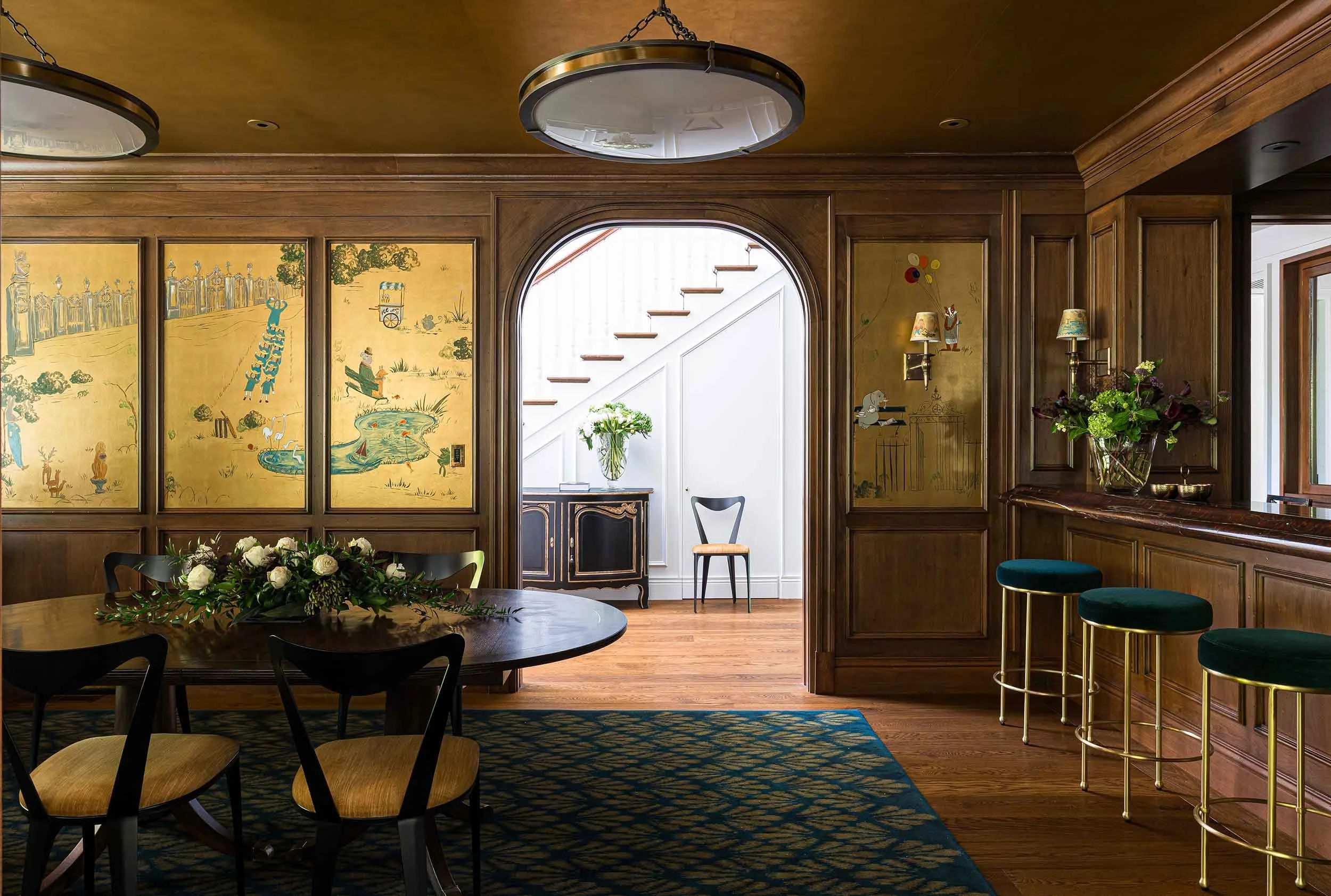 Custom bar room with walnut-paneled walls, hand-painted murals, gold leaf ceiling, and arched doorway in Norman
Charles Construction home.