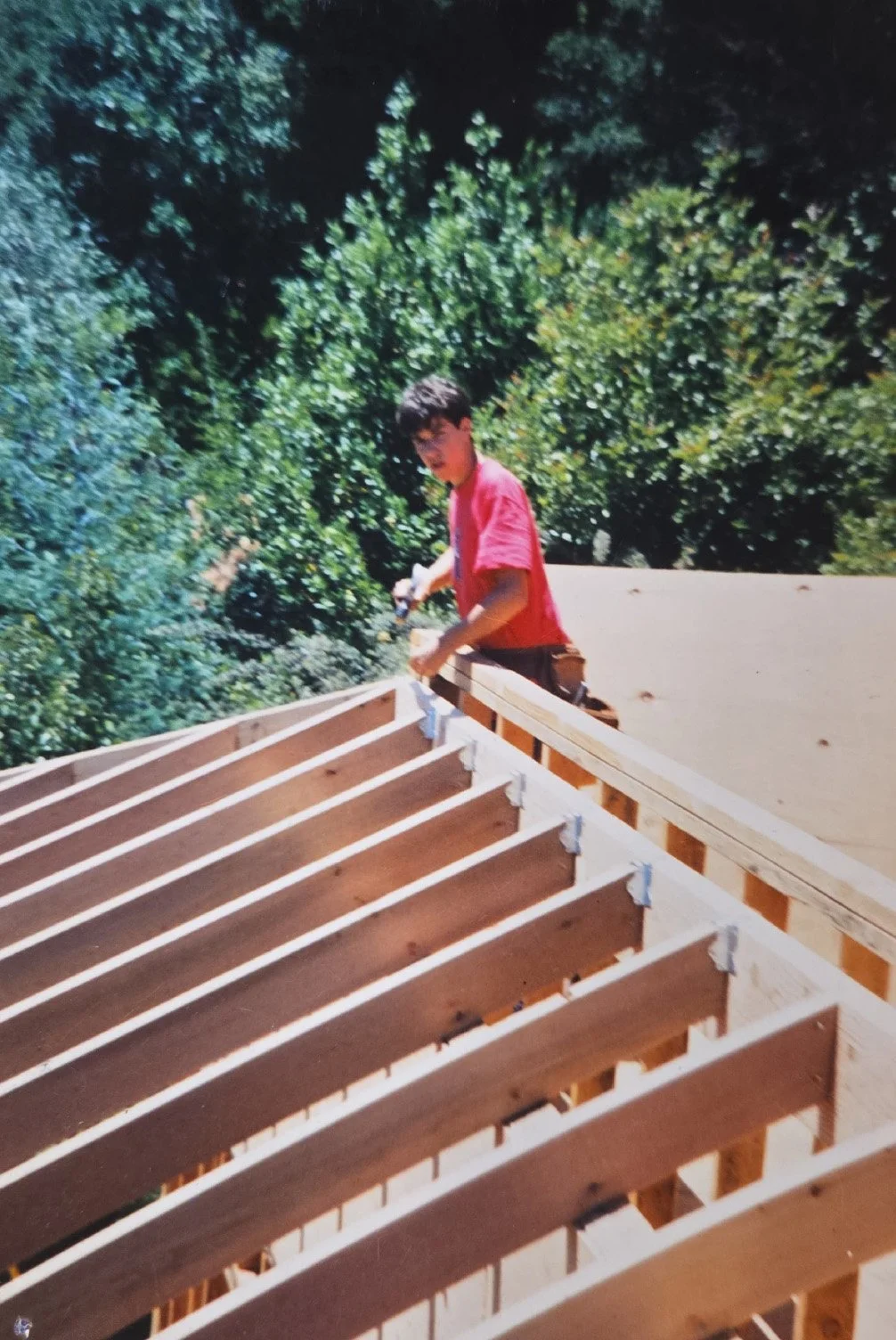 Craftsman installing roofing on a custom home by Norman Charles Construction.