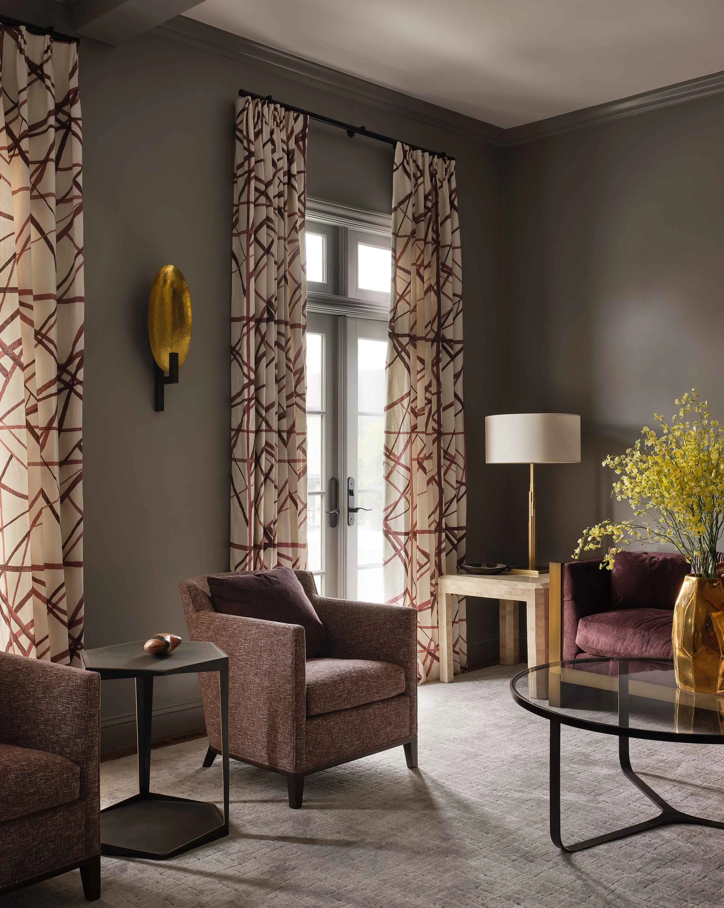 ncc-victorian-renovation-living-room-seating-area-patterned-drapes-gold-sconce.jpg