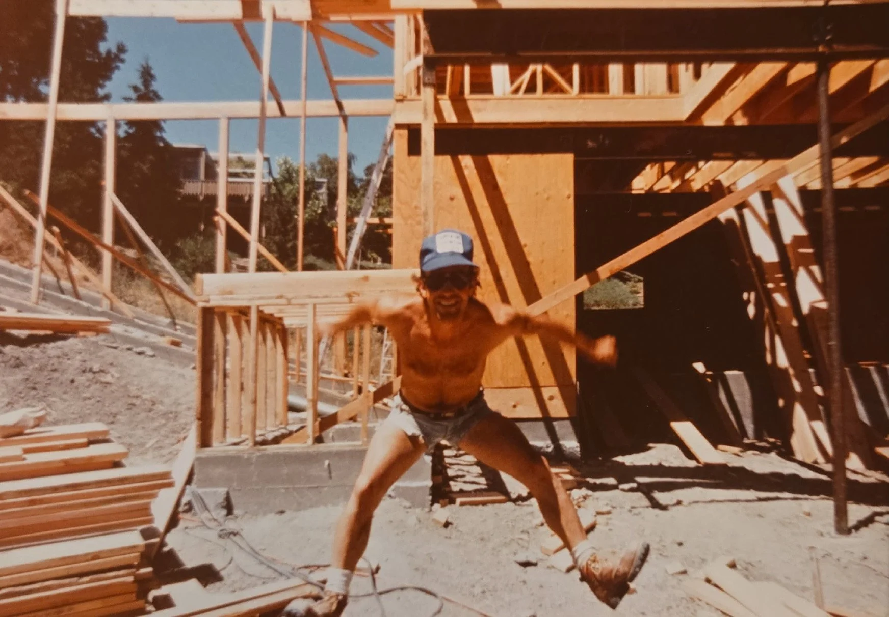 Norman Charles framing a residential custom home in the 1980s, early years of Norman Charles Construction.