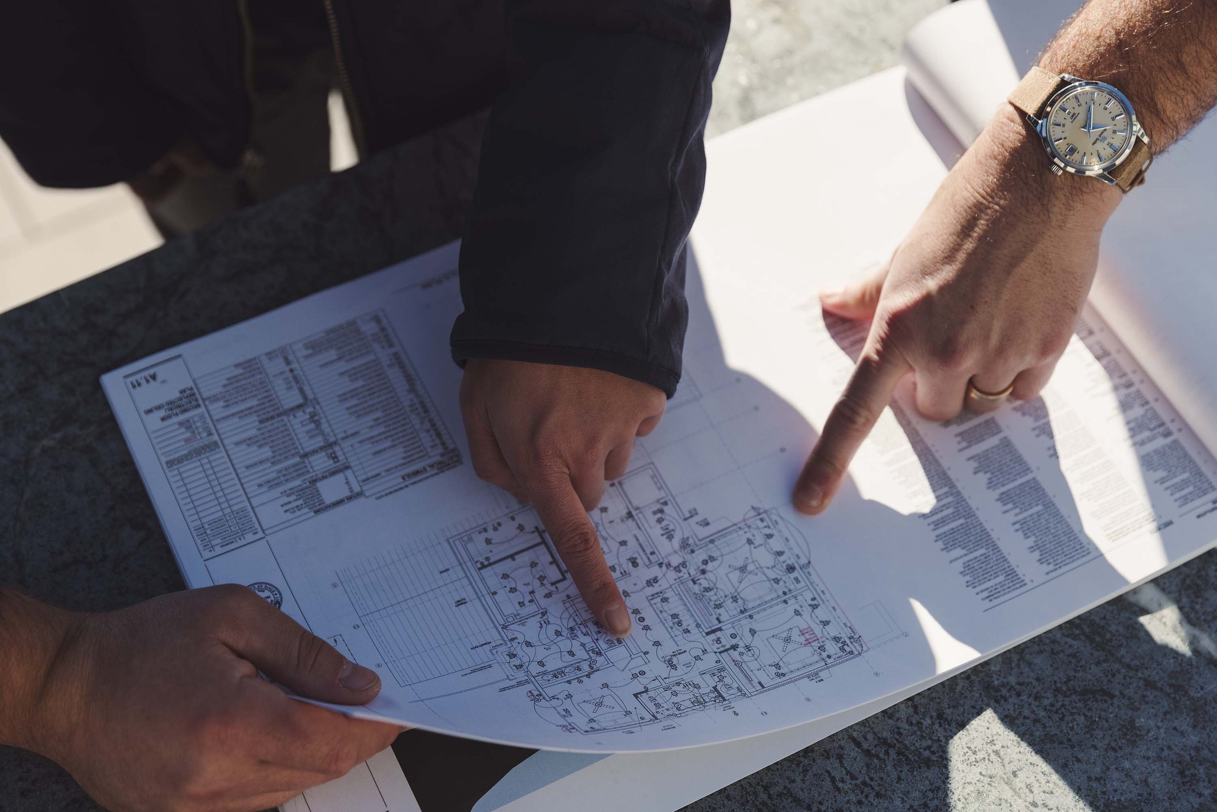 Norman Charles Team reviewing Plans on a job site