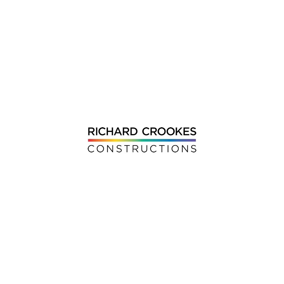Logo for Richard Crookes Constructions featuring black text and a rainbow-colored line