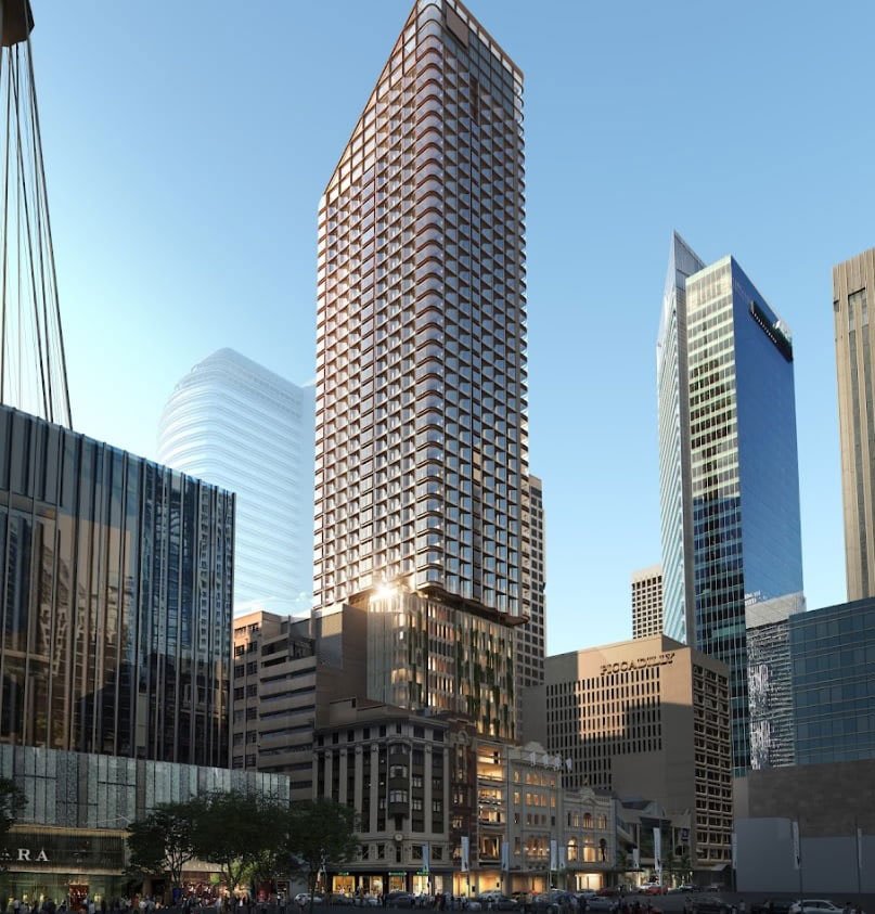 Tall modern skyscrapers in a city skyline with a clear blue sky.