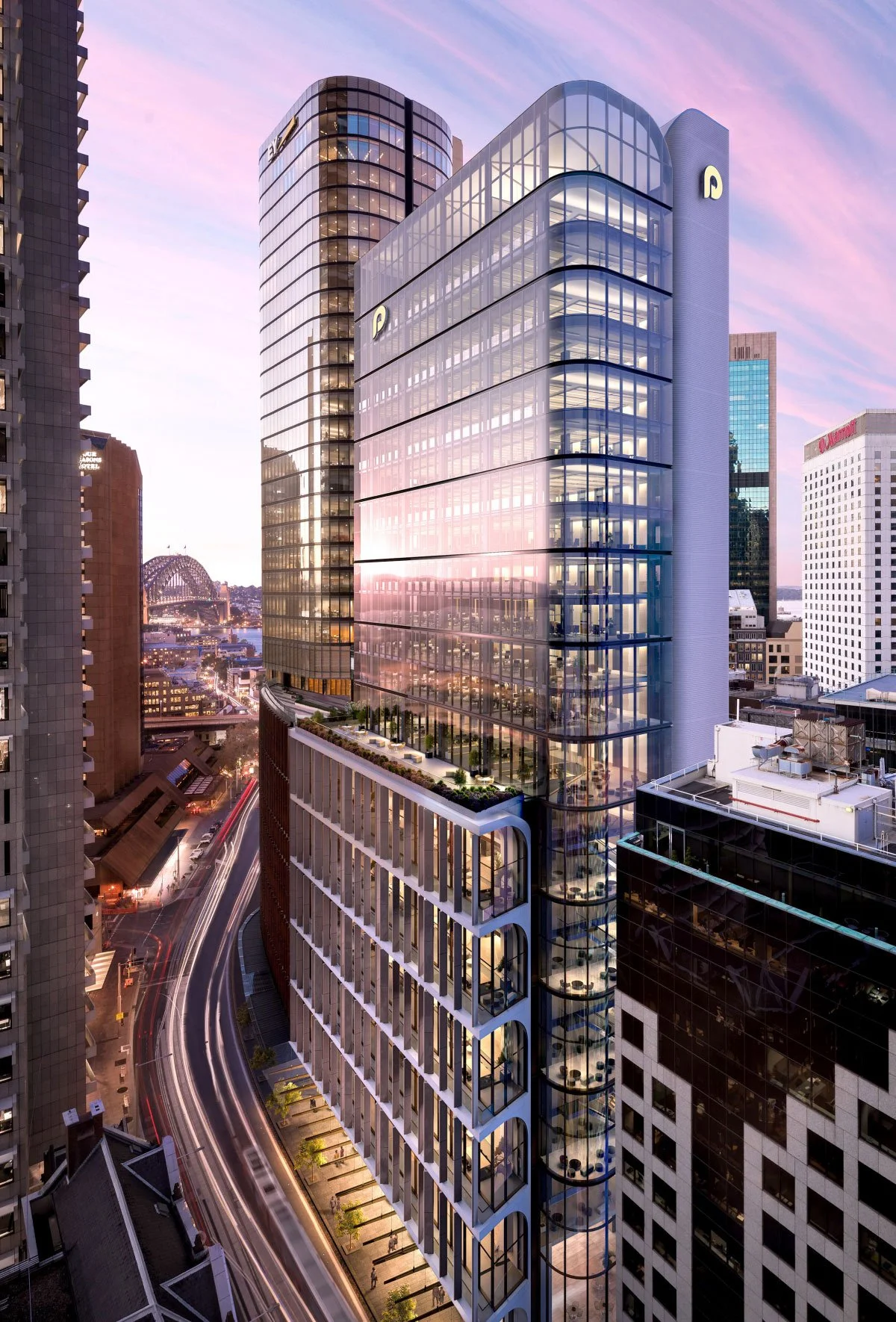 A modern cityscape at dusk featuring a tall glass office building with curved edges and balconies, reflecting the colorful sky, with other high-rise buildings nearby and a bridge in the background.