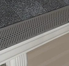 Standard perforated aluminum gutter guard installed on a gutter