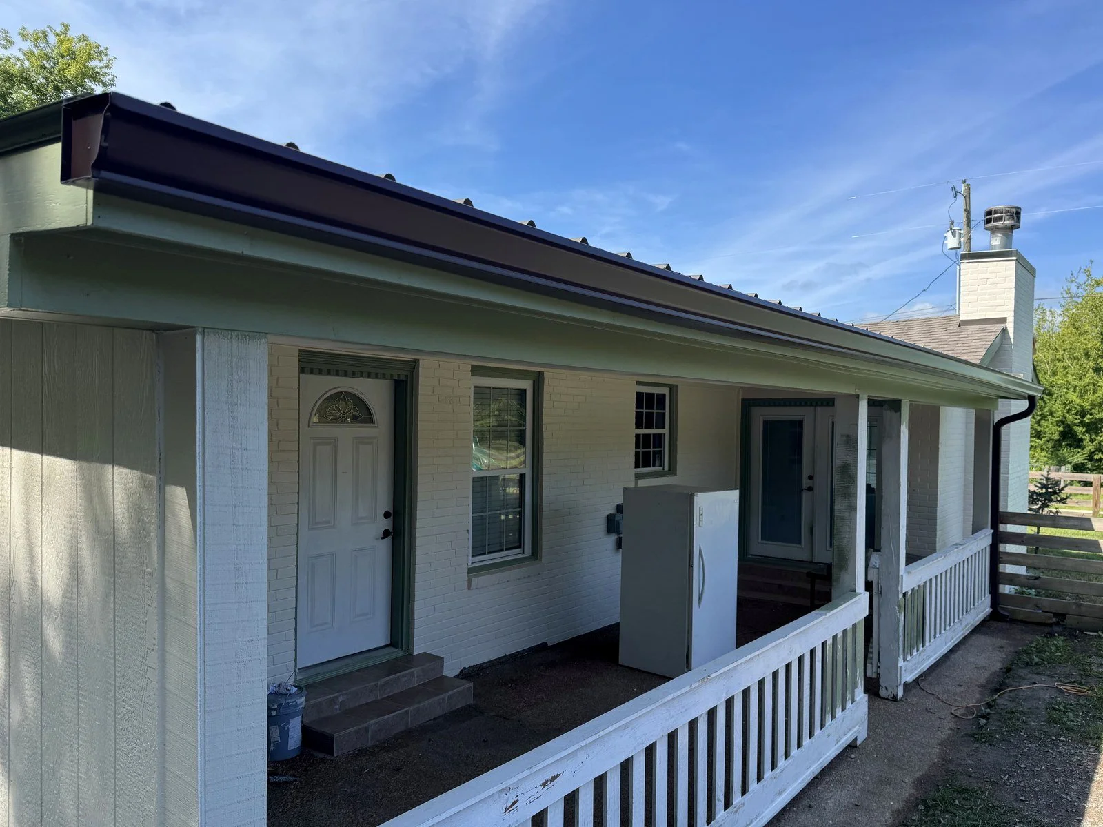 After: the same porch with new brown seamless gutters, Franklin area