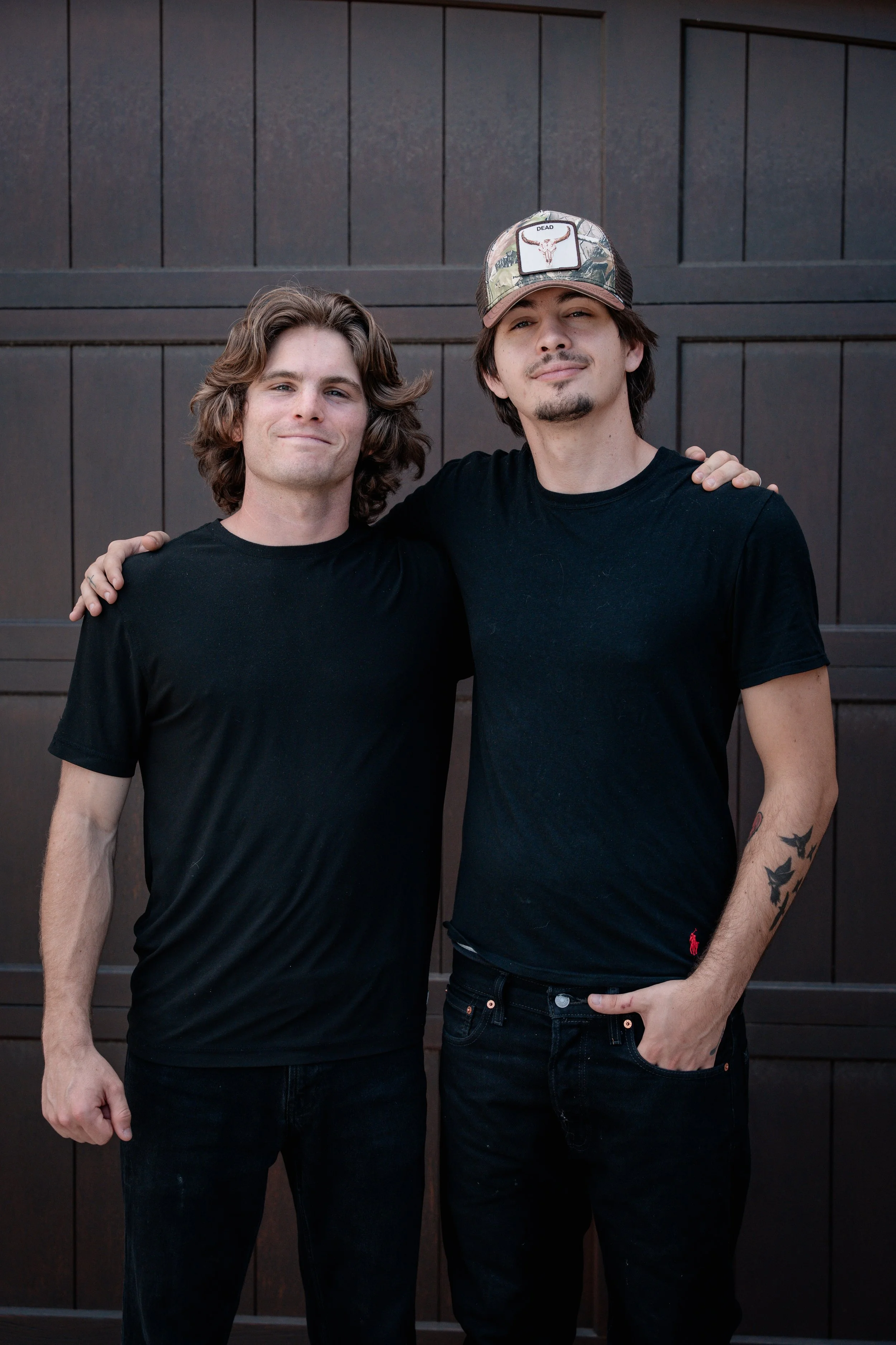 two guys smiling at camera posing