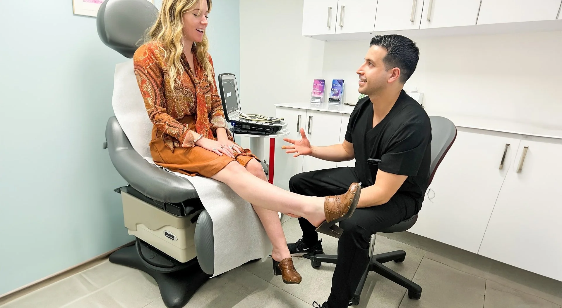 Alt text: Medical consultation between a doctor and patient at a vein clinic