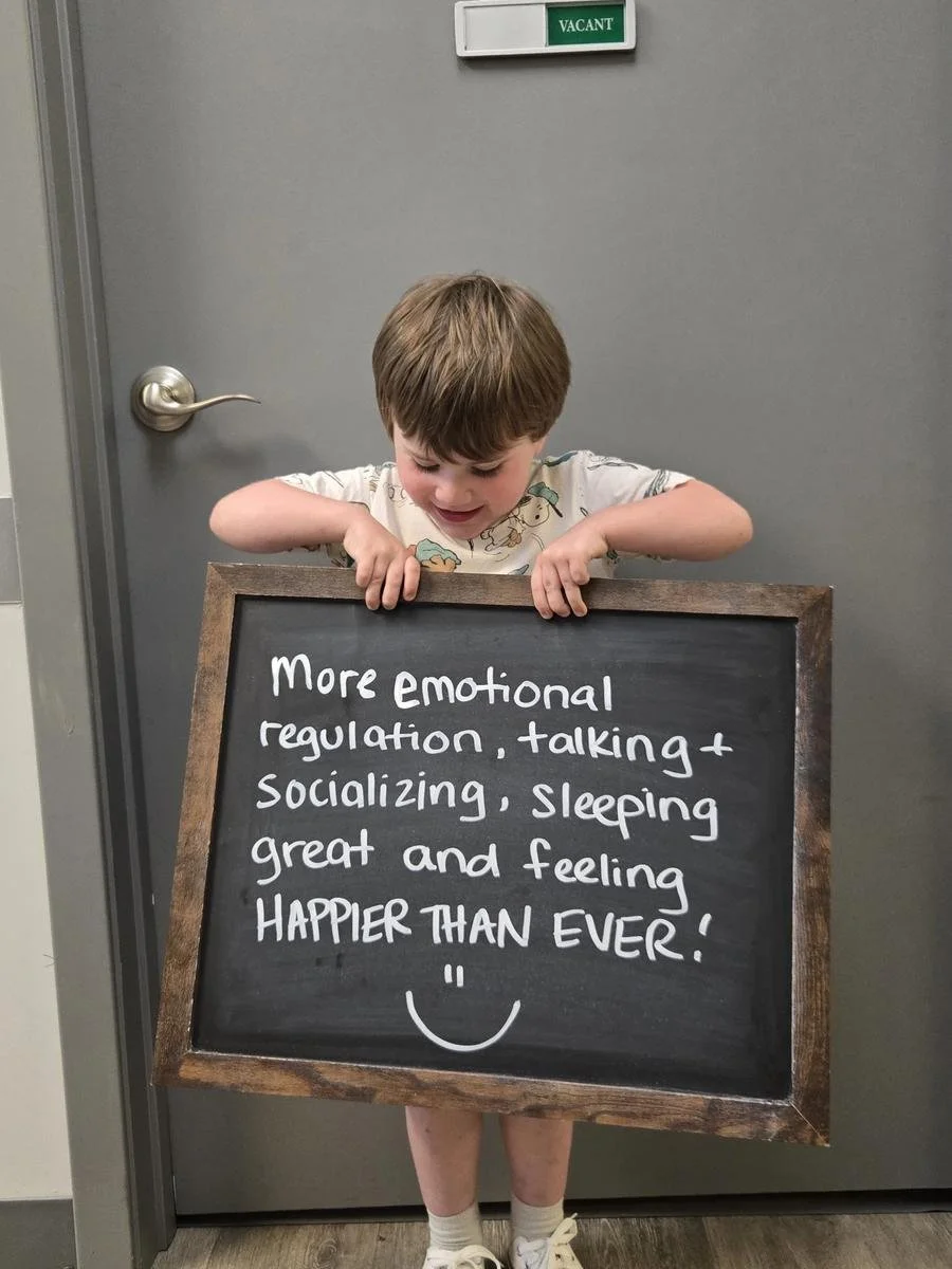 Boy holding chalkboard about emotional regulation and sleeping after sensory processing care in Liberty MO