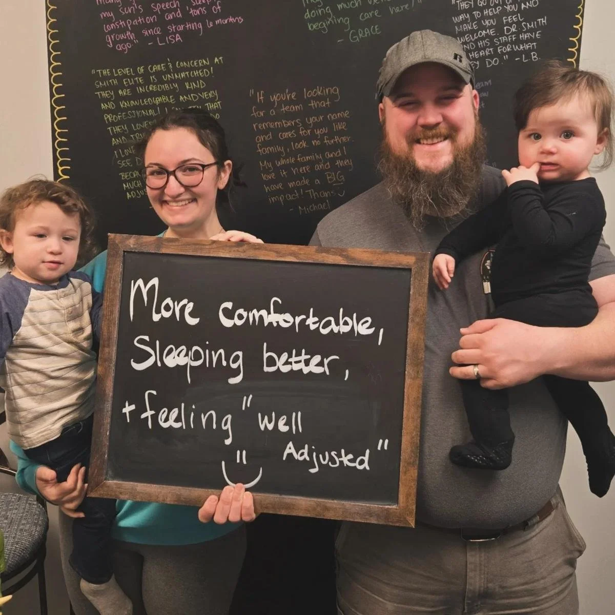 Infant and family together during reflux chiropractic visit in Liberty MO