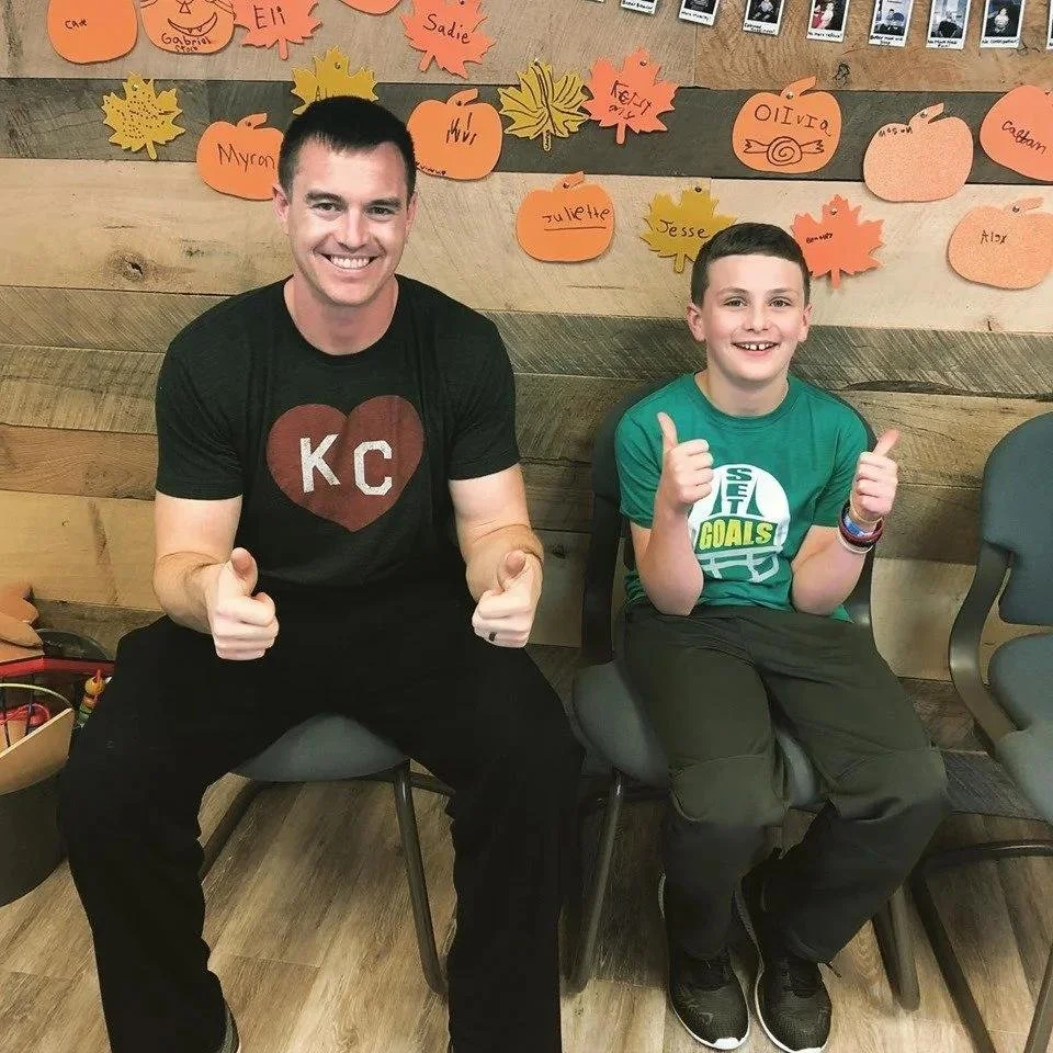 Dad and son smiling during autism nervous system chiropractic visit