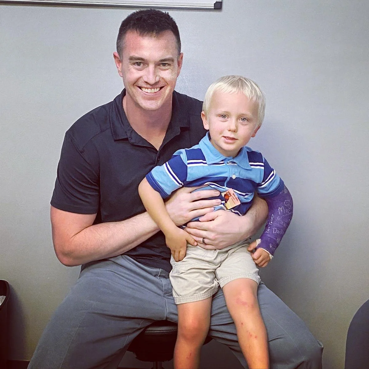 Dr Garrett Smith with smiling young boy during ADHD focus chiropractic care in Liberty MO