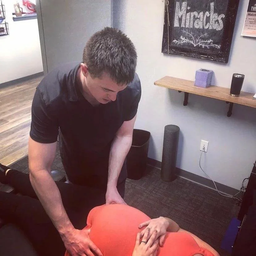 Close-up of sacral adjustment for round ligament pain relief in Liberty MO