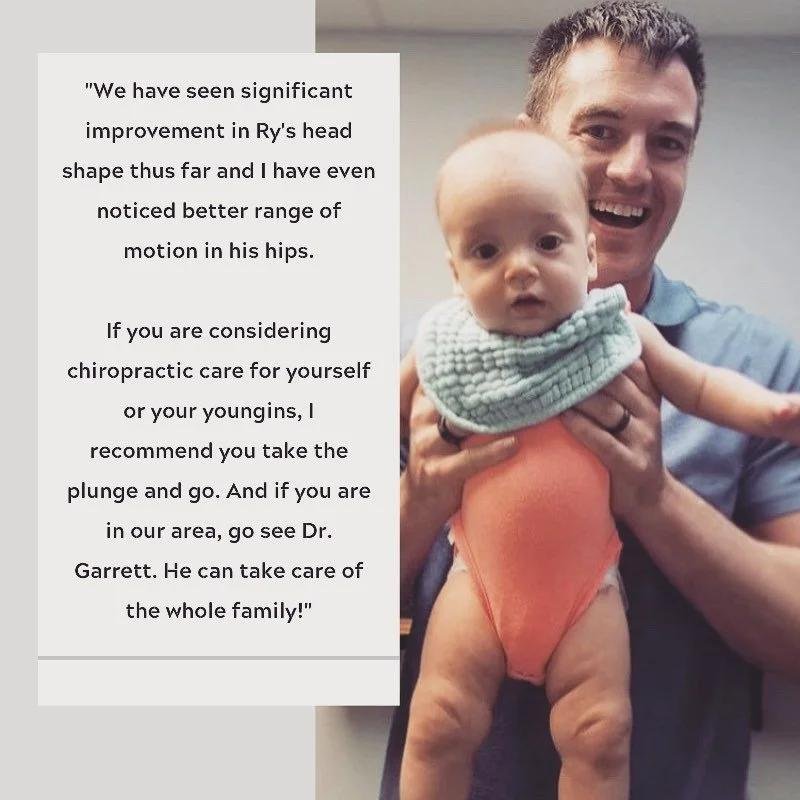 Dr holding baby with torticollis improvement after chiropractic treatment in Liberty MO