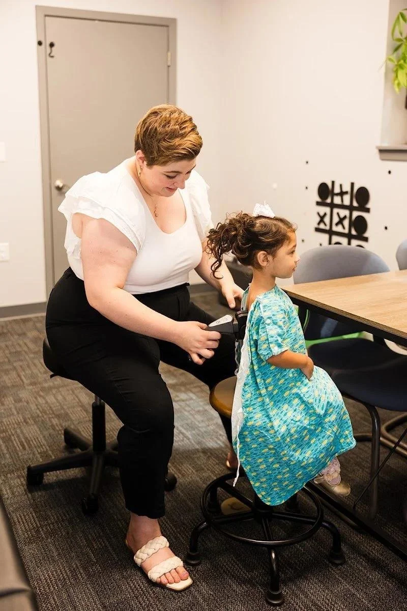 Girl receiving gentle chiropractic care during kids visit