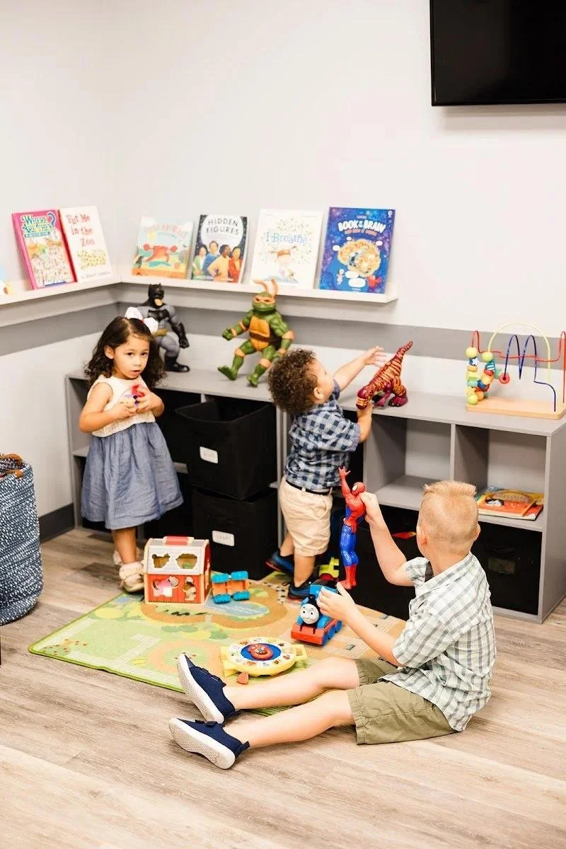 Child in family-friendly treatment room with play area for kids chiropractic in Liberty MO