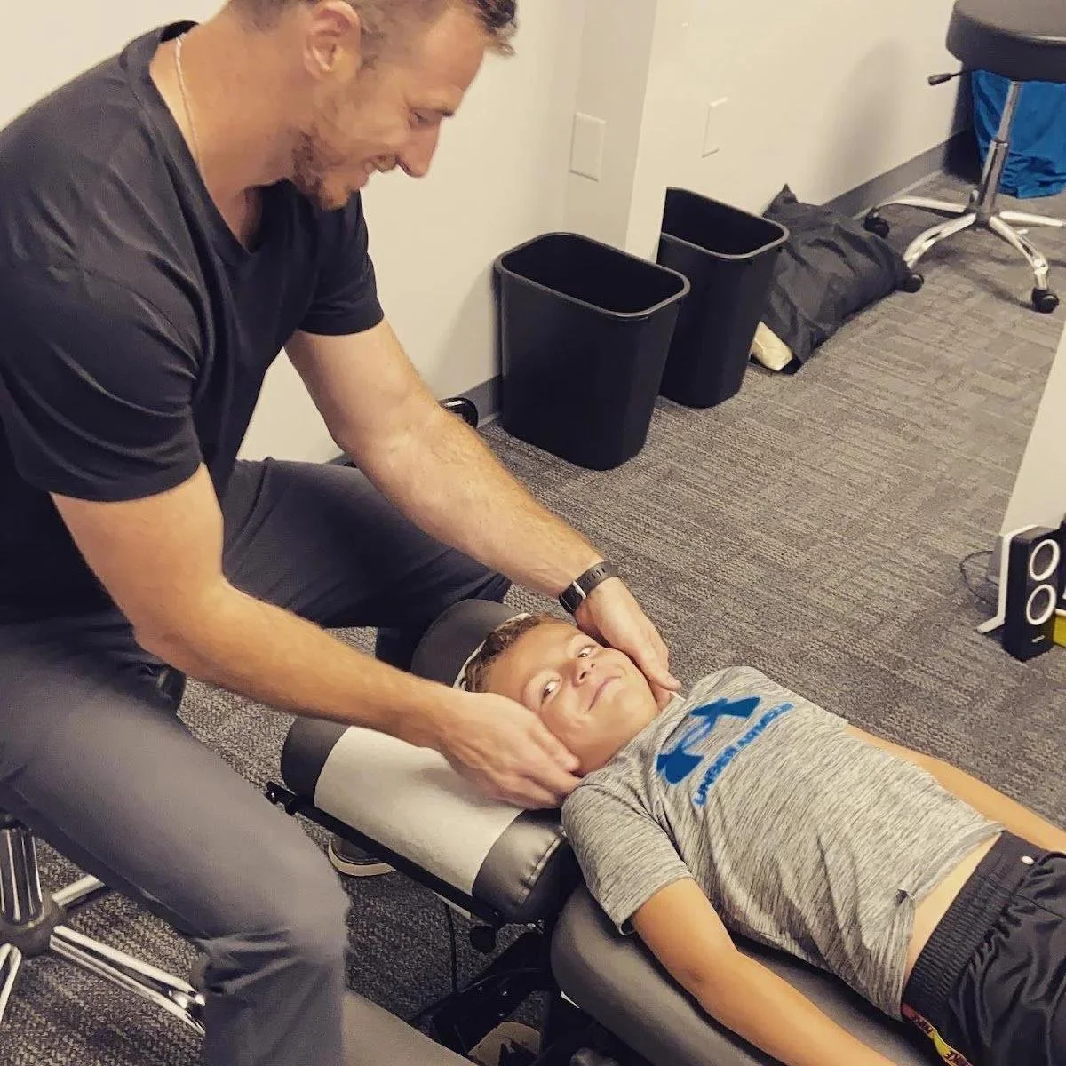 Dr Garrett Smith adjusting boy for North Kansas City families